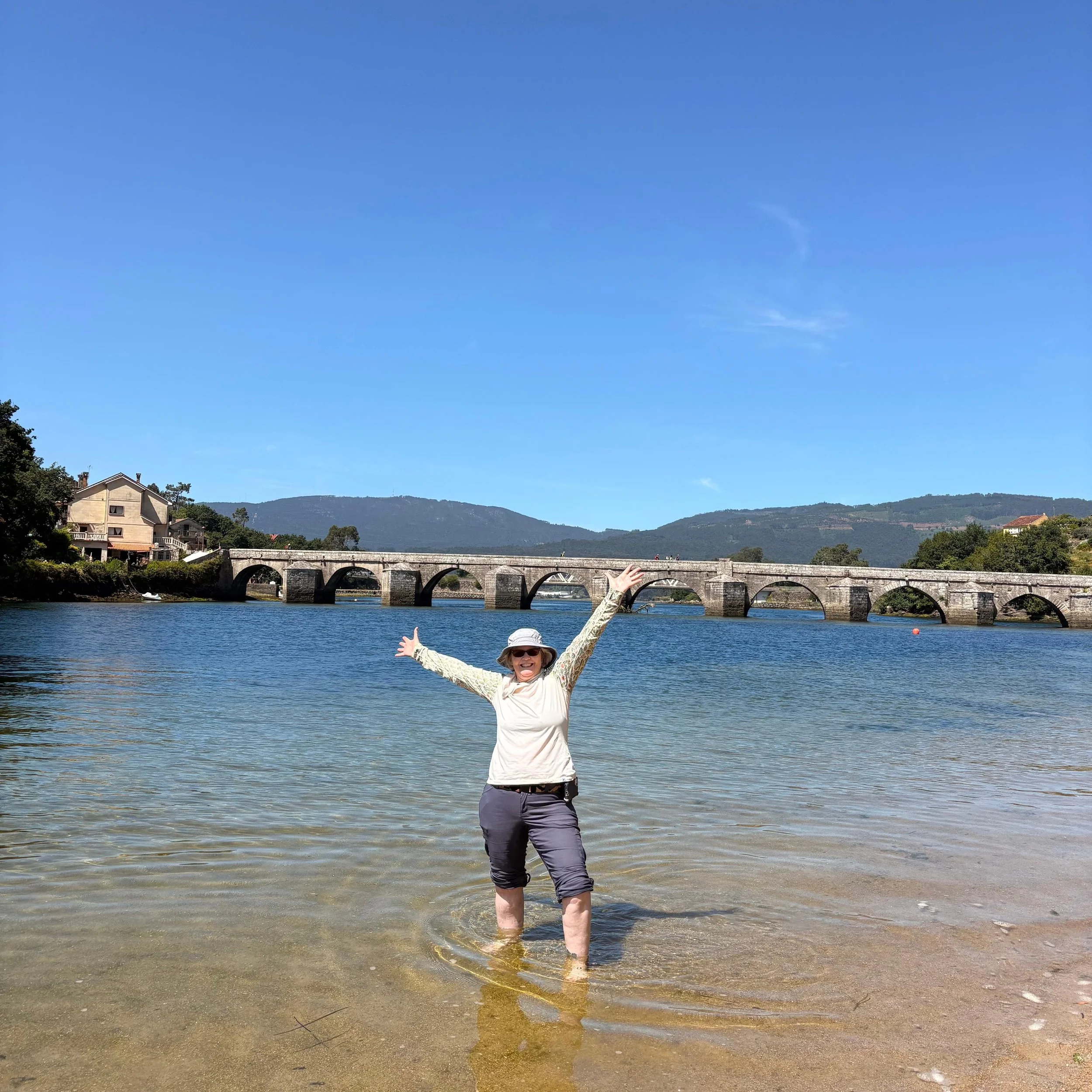 women standing in river walking the camino de santiago portuguese way