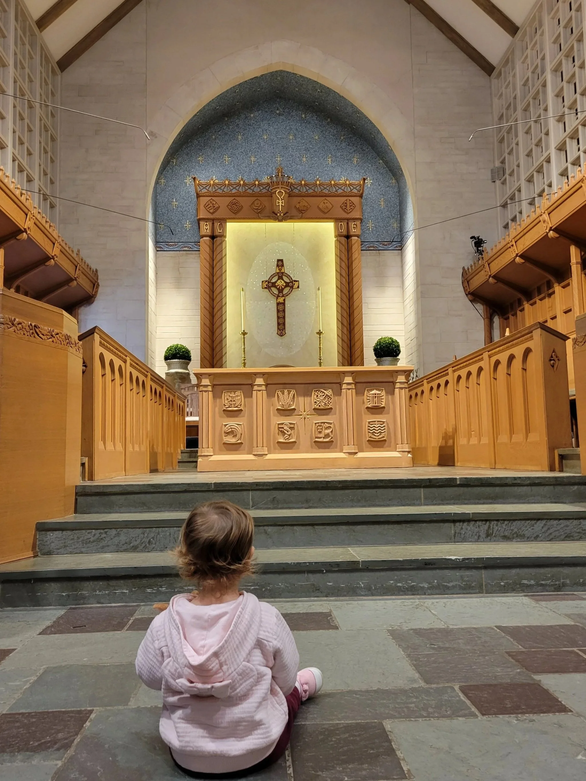 Child sitting at the altar, at the feet of Jesus, Children belong in church.