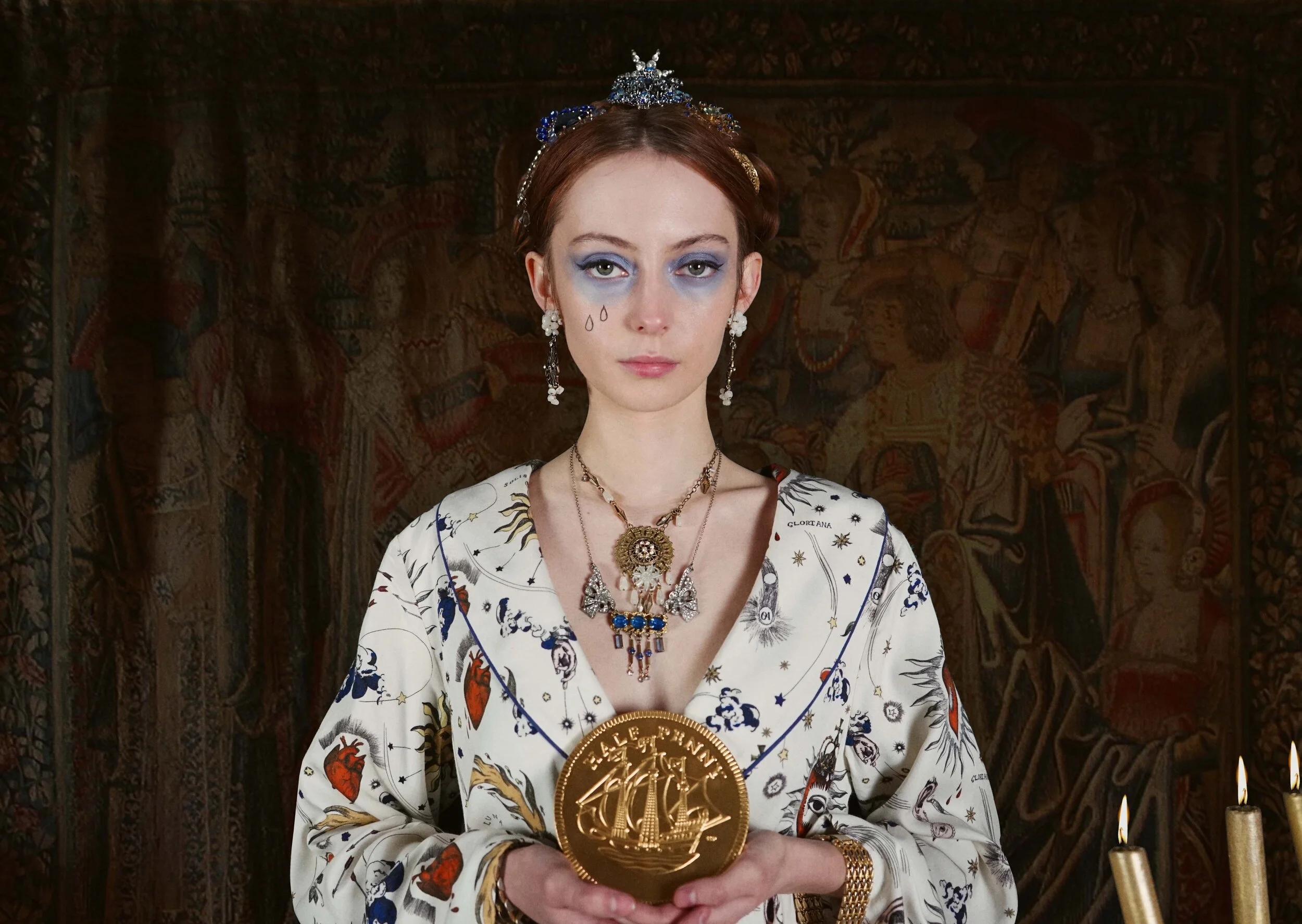 When planning the collaboration with Olivia Annabelle, where did you look for inspiration?    It was a perfect opportunity to look again at the great paintings of Queen Elizabeth I dressed in all her majestic finery, and to wider examples of Tudor jewellery to get a feel for the shapes and motifs which were popular. I also loved revisiting the costumes and styling of Cate Blanchett in the two films about Elizabeth. But I also wanted to bring a sense of timelessness to the collection and I wanted to reflect how our fascination with symbolic and statement jewellery has endured through the centuries. That’s why it was important for me to use costume jewellery pieces from right across the 20th century – from the 1900s to the 1990s.   What is your favourite piece from the collection?   I absolutely loved putting the Gloriana Halo Crown together, starting with the Edwardian paste moon-shaped dress ornament and the Art Deco era paste star brooch, both which I already had in my stash of vintage treasures, and then sourcing the other pieces of vintage jewellery to echo the rich royal blue hue that runs through the Olivia Annabelle print. But I think my absolute favourite is the OA Eye, created from an oval early 20th century paste dress buckle. The design came to me in a flash of inspiration. I had all the little component pieces here in the studio and everything came together in such perfect harmony!   What led you to become a jewellery designer?   That’s interesting and quite difficult to pinpoint as it happened almost accidentally. I have always enjoyed creative activities, but I took a more academic route at university, studying history, obtaining a PhD and becoming a researcher and university lecturer. When on maternity leave with my third daughter I decided that I wanted to explore more creative avenues and focused on how I might use my passion for vintage costume jewellery and treasure hunting at antiques markets and boot sales in this endeavour. Prompted by my cousin’s success as a wedding cake designer, I began to look at the growing opportunities in the area of bridal fashion and could see an increasing demand for distinctive and meaningful accessories for weddings and special occasions. So, I began designing jewelled headpieces for brides, using reworked vintage jewellery elements. Over time, my range has grown to include earrings, necklaces and bracelets - though headwear remains at the heart of my collections.