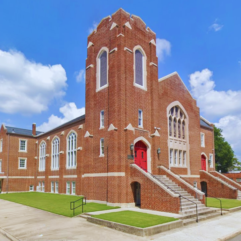 Street view of the brick church building exterior of the First Baptist Church of Ahoskie, NC from the corner of West Street and Main Street