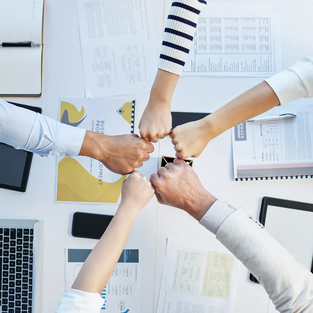 Teamwork fists bump in office