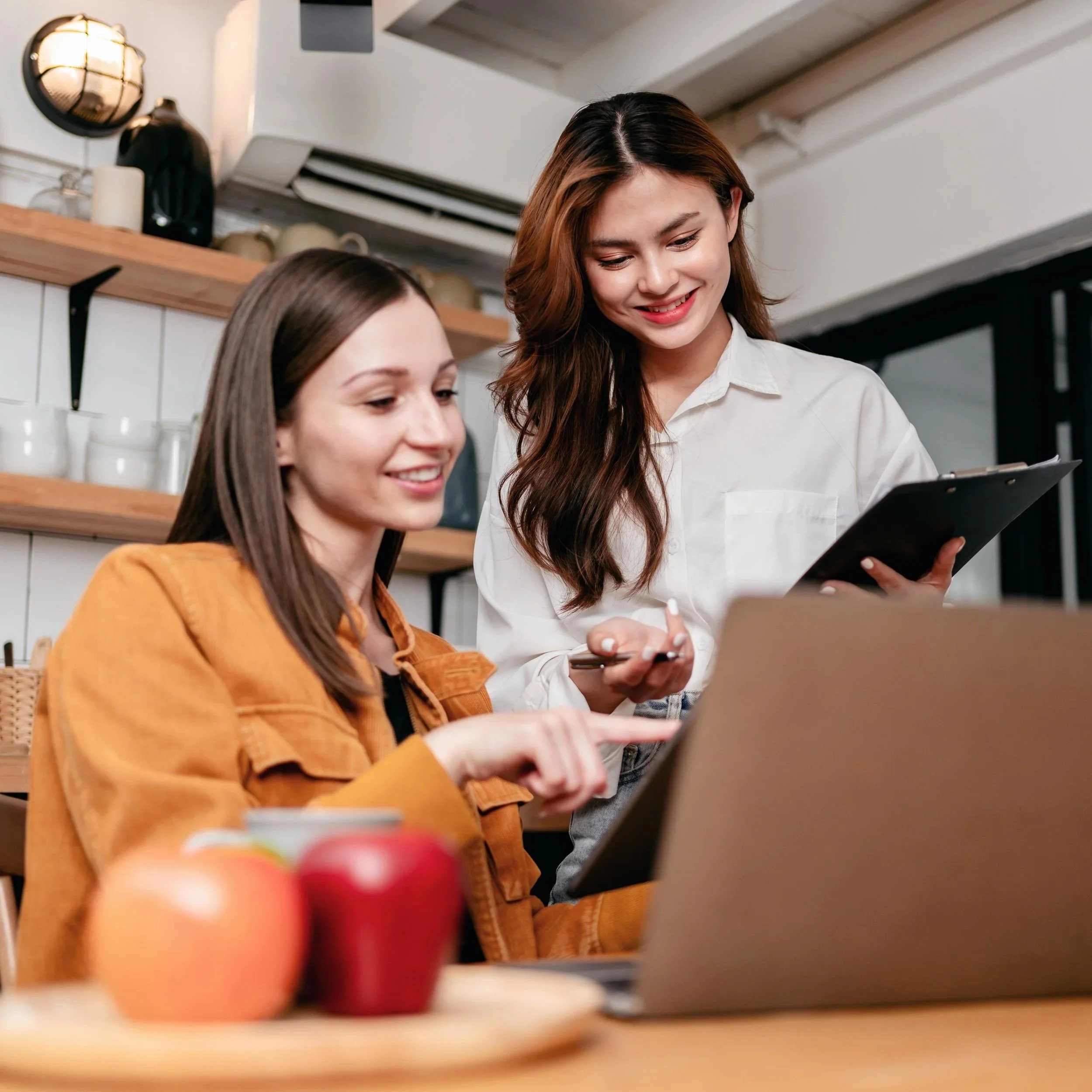 two-women-working-together-over-a-laptop-2026-01-05-05-37-21-utc.jpg