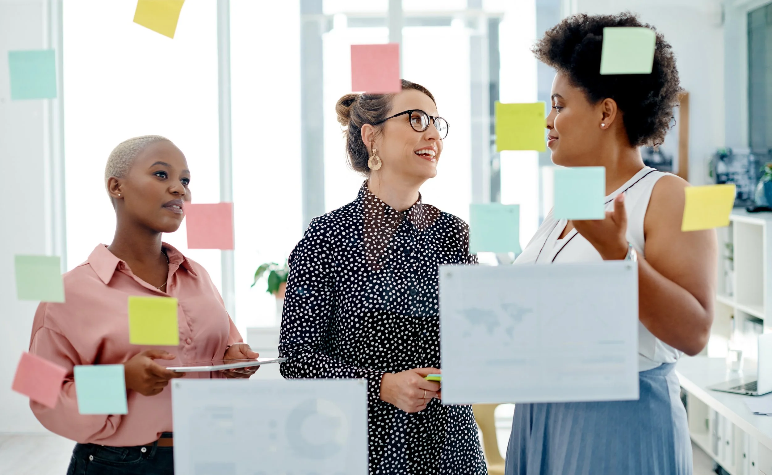 women collaborating in office