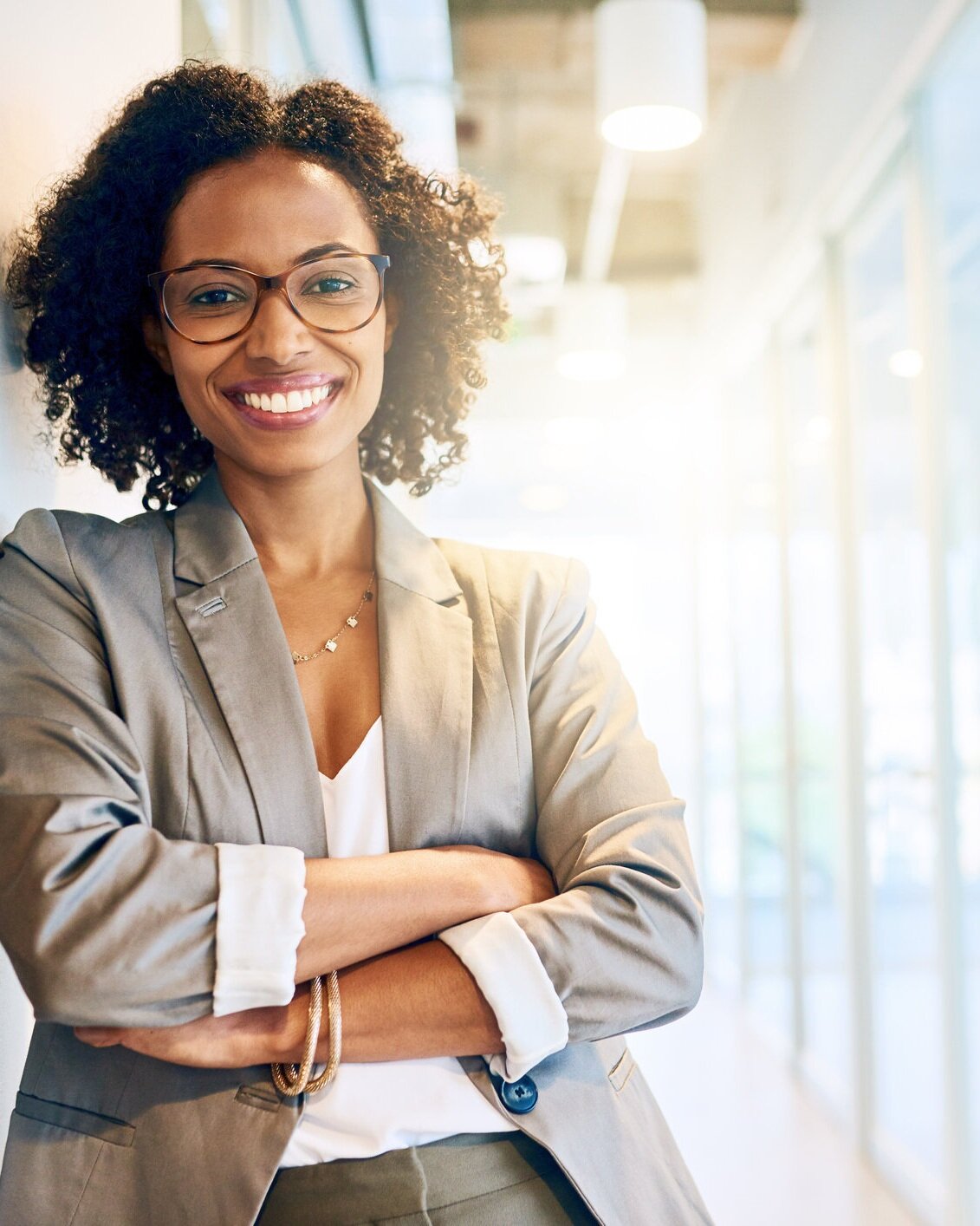 Woman standing with arms crossed happy