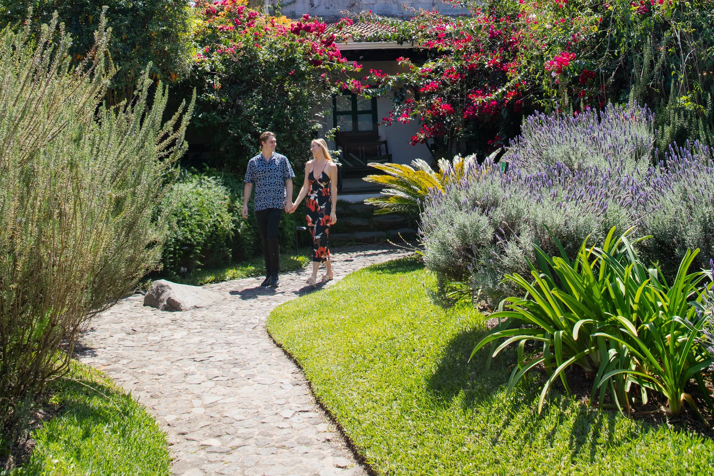A couple strolling around the gardens of Conceptio Hotel in Antigua Guatemala