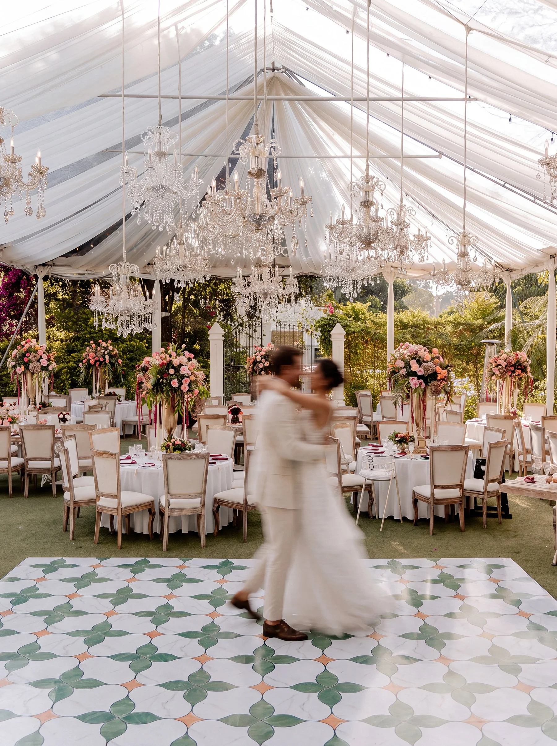 Elegant wedding reception tables set in Conceptio's garden at golden hour