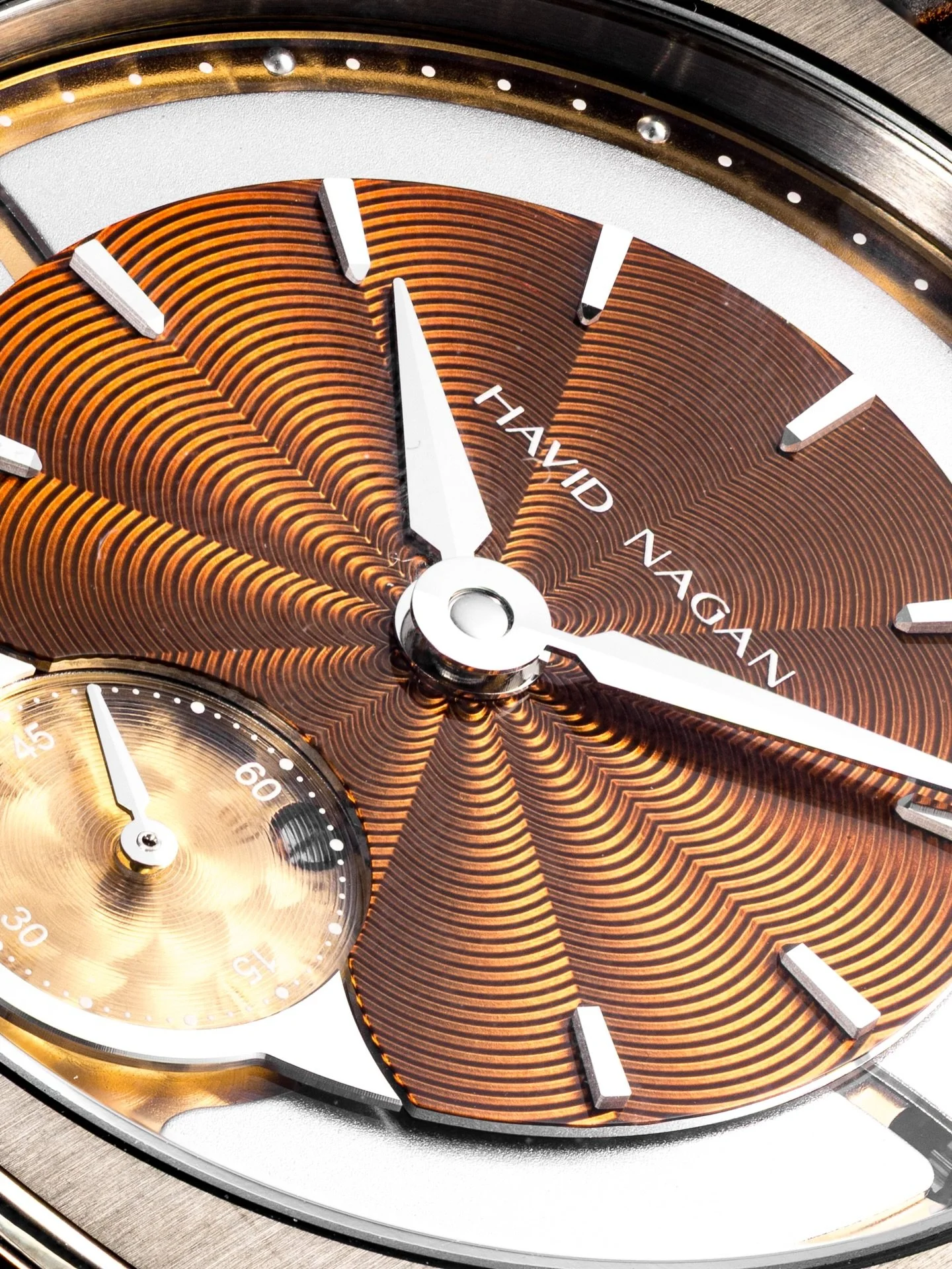 HN02 Ember / Waves for Azure, flames for Ember. Each dial is hand engraved, then a translucent enamel paint is applied, baked at 850 degrees Celsius, and finally varnished to accentuate the underlying tones.