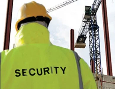 Security guard overseeing construction machinery and equipment to protect against theft and vandalism on Ontario job site