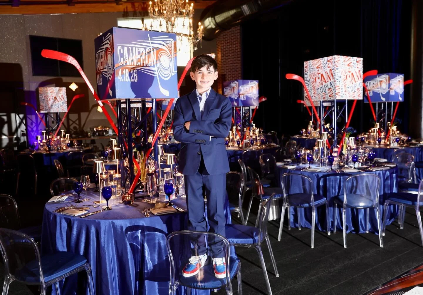 This hockey-themed bar mitzvah was all about bringing arena energy to the celebration. When guests walked into &ldquo; Bernstein Arena&rdquo;- GAME NIGHT commenced.
Bold lighting, dramatic tables capes and Camerons favorite players adorned the space.