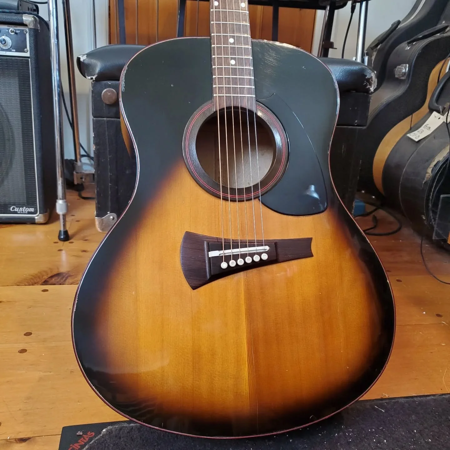 Late 70s Gibson MK-53 came in for a bridge reglue, loose binding, top crack, chewed up bridge plate, and a setup. Apparently Gibson thought this was the future of acoustic guitars at the time. Its odd fan bracing has not done a great job of keeping t