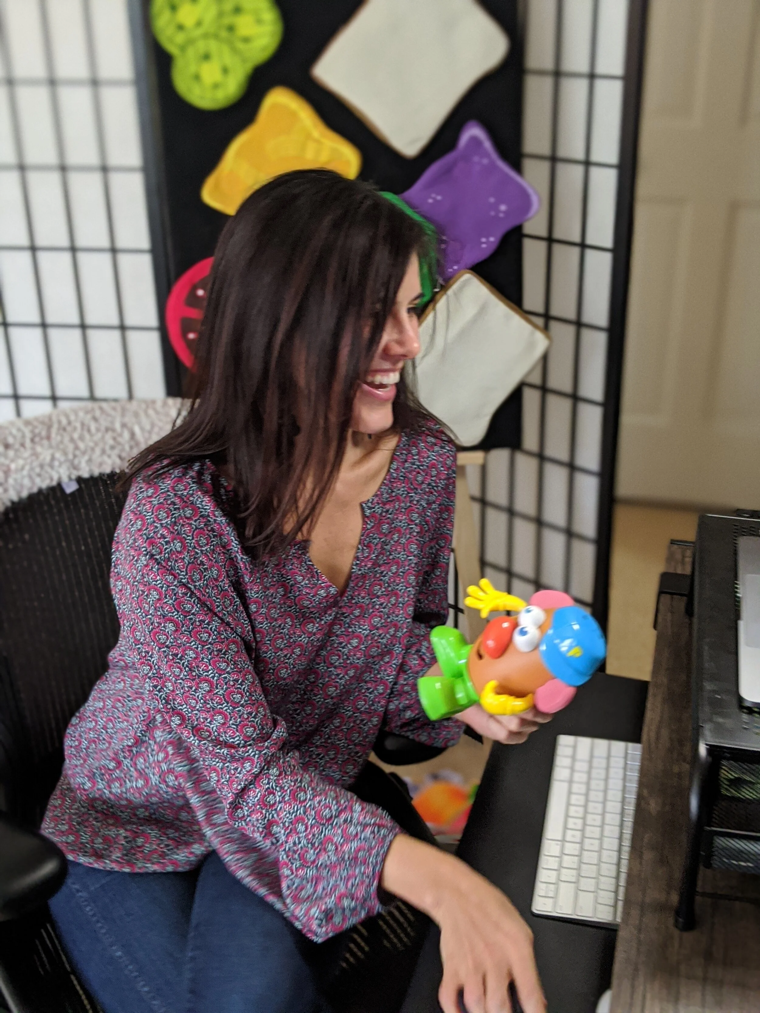 Speech-language pathologist leading an engaging online speech therapy session with a child using hands-on materials.