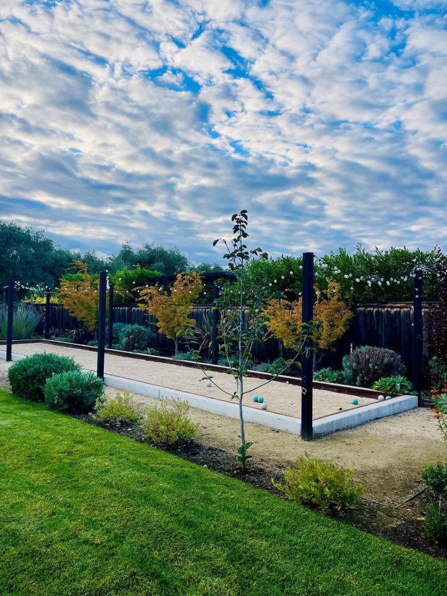 Residential patio, court, and planting design with string lighting