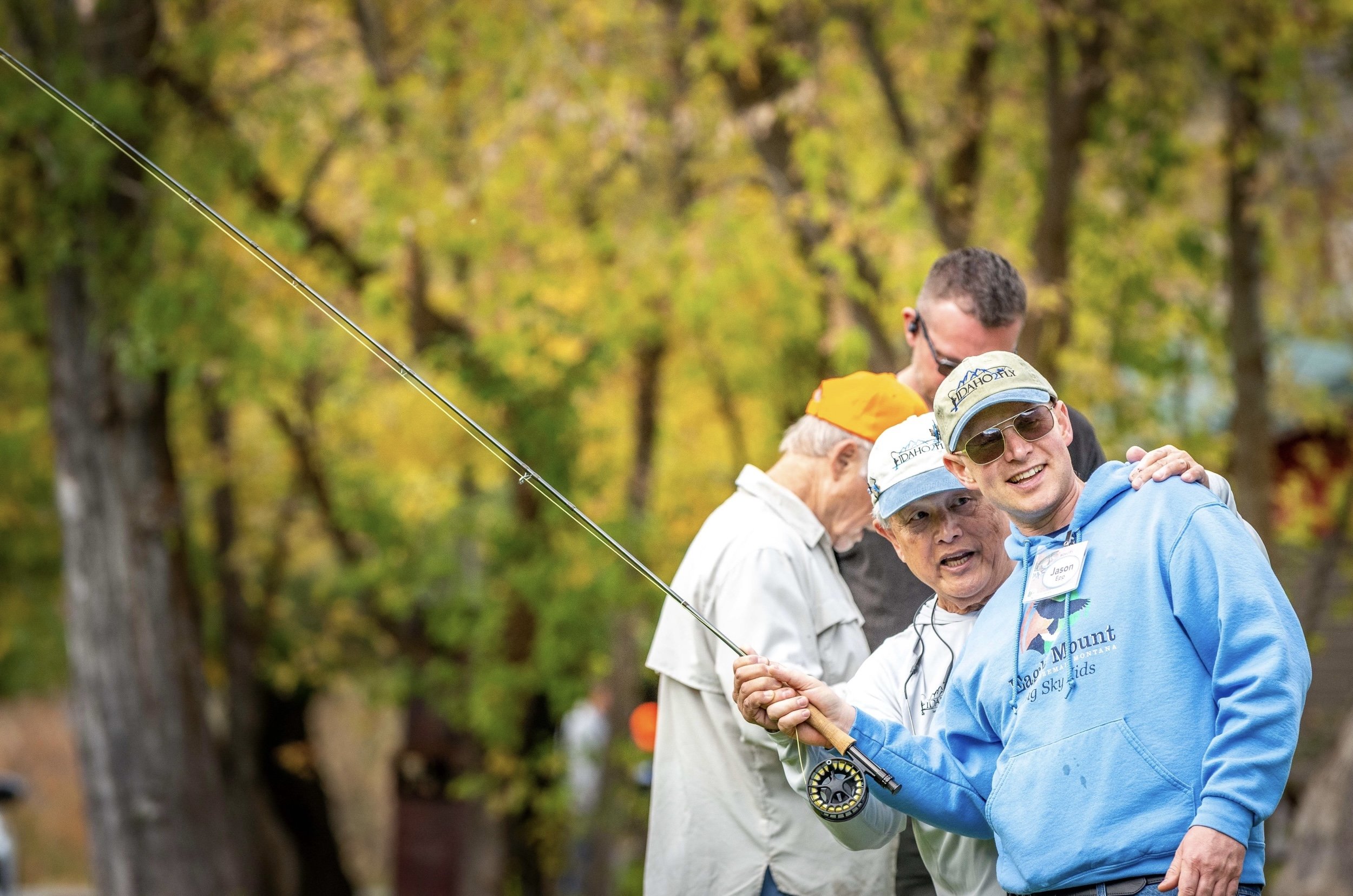 Volunteer Helping Retreat Guest Learn Fly Casting