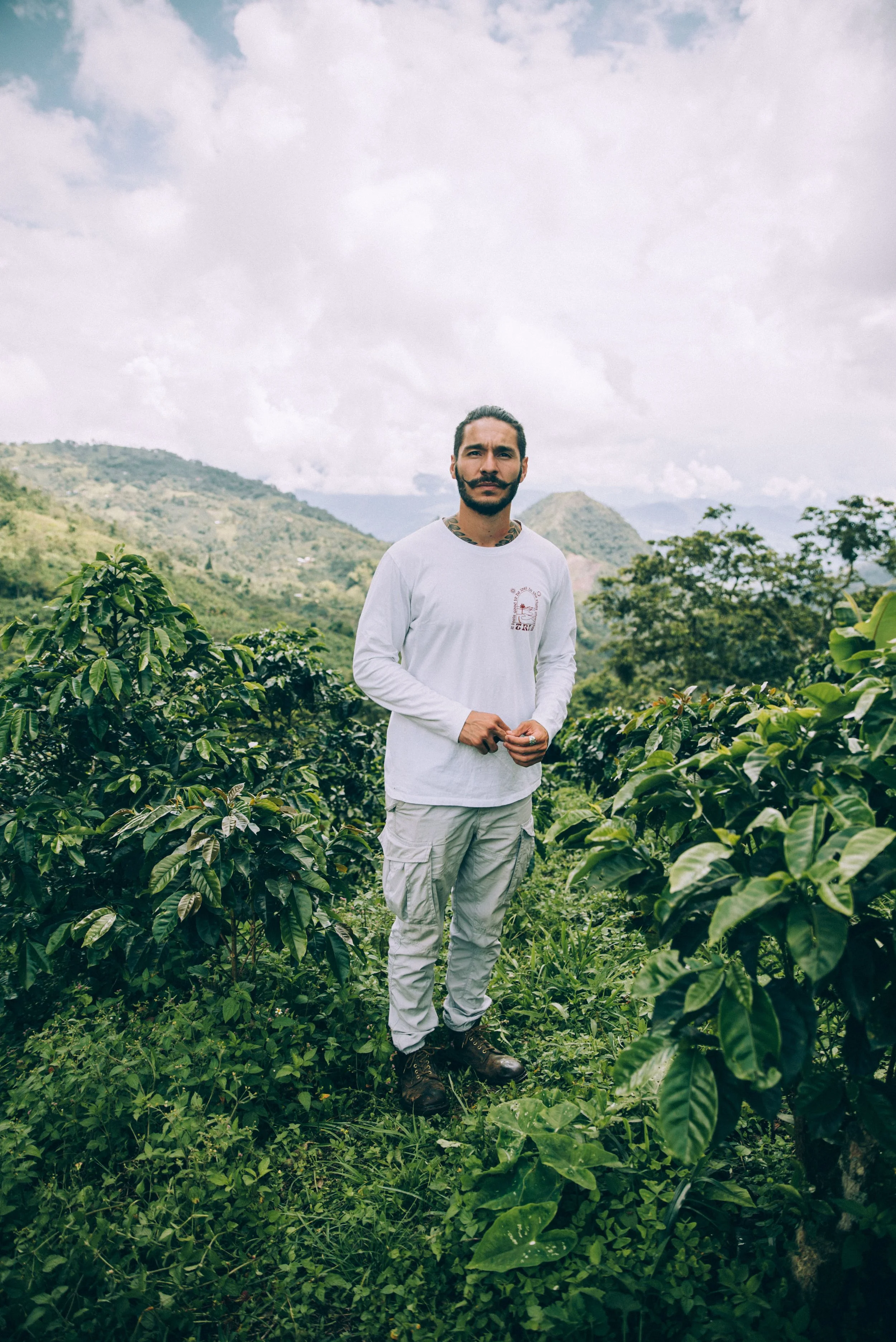 Portrait of founder and owner of KWC Coffee, Juan Diaz, standing amidst Finca el Vergel coffee farm in Venecia, Antioquia, Colombia