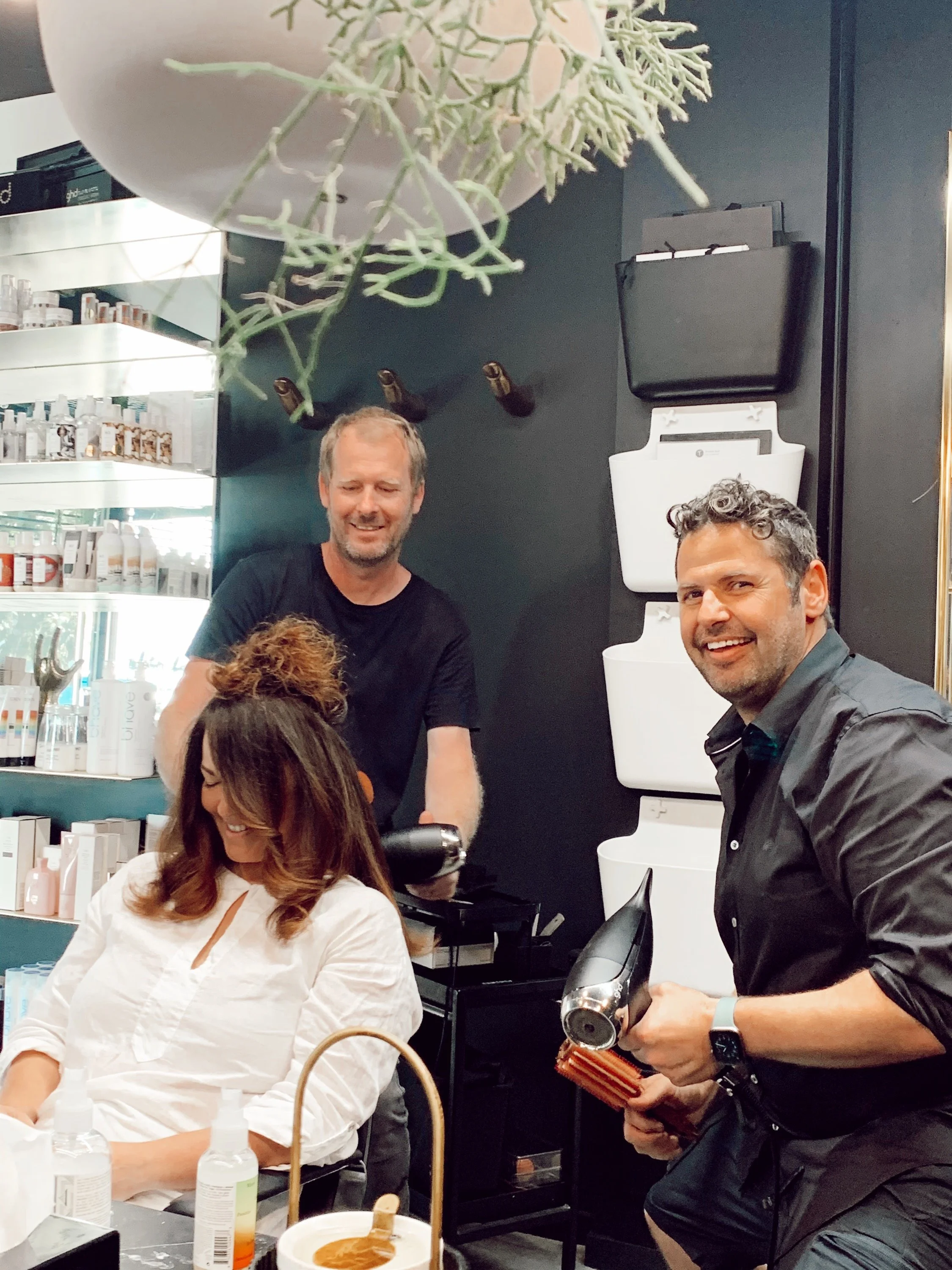 Hairdressers cutting a womens hair