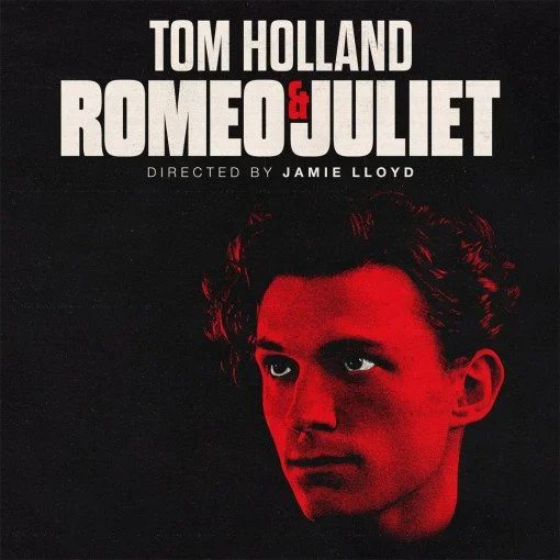 Movie poster for 'Romeo and Juliet' starring Tom Holland, directed by Jamie Lloyd, featuring a close-up of Tom Holland's face with a red lighting effect.