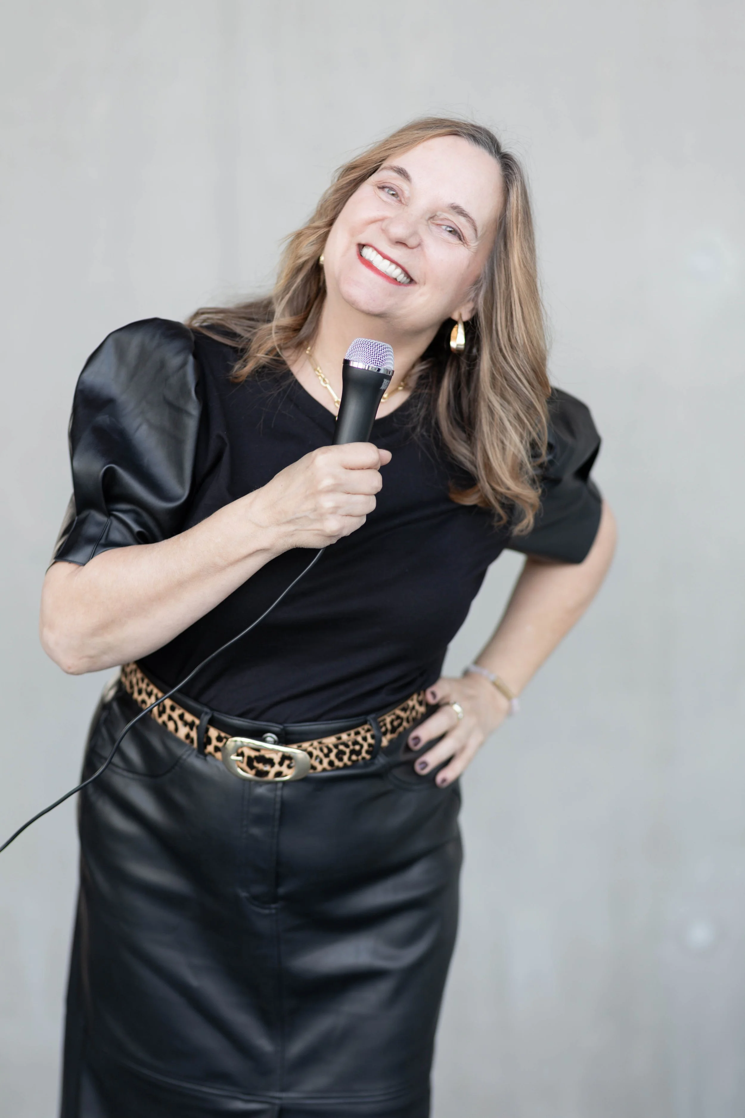 Linda Drosdowech speaking on stage with a microphone