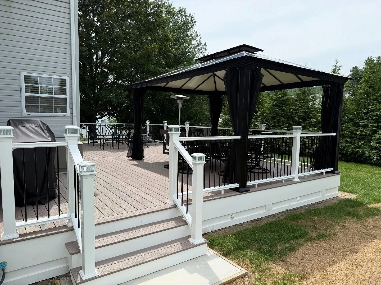 Fiberon deck with composite railing and aluminum balusters. Intergrated hardtop gazebo to railings. #decksofinstagram #decks #gazebo #fiberon #rails