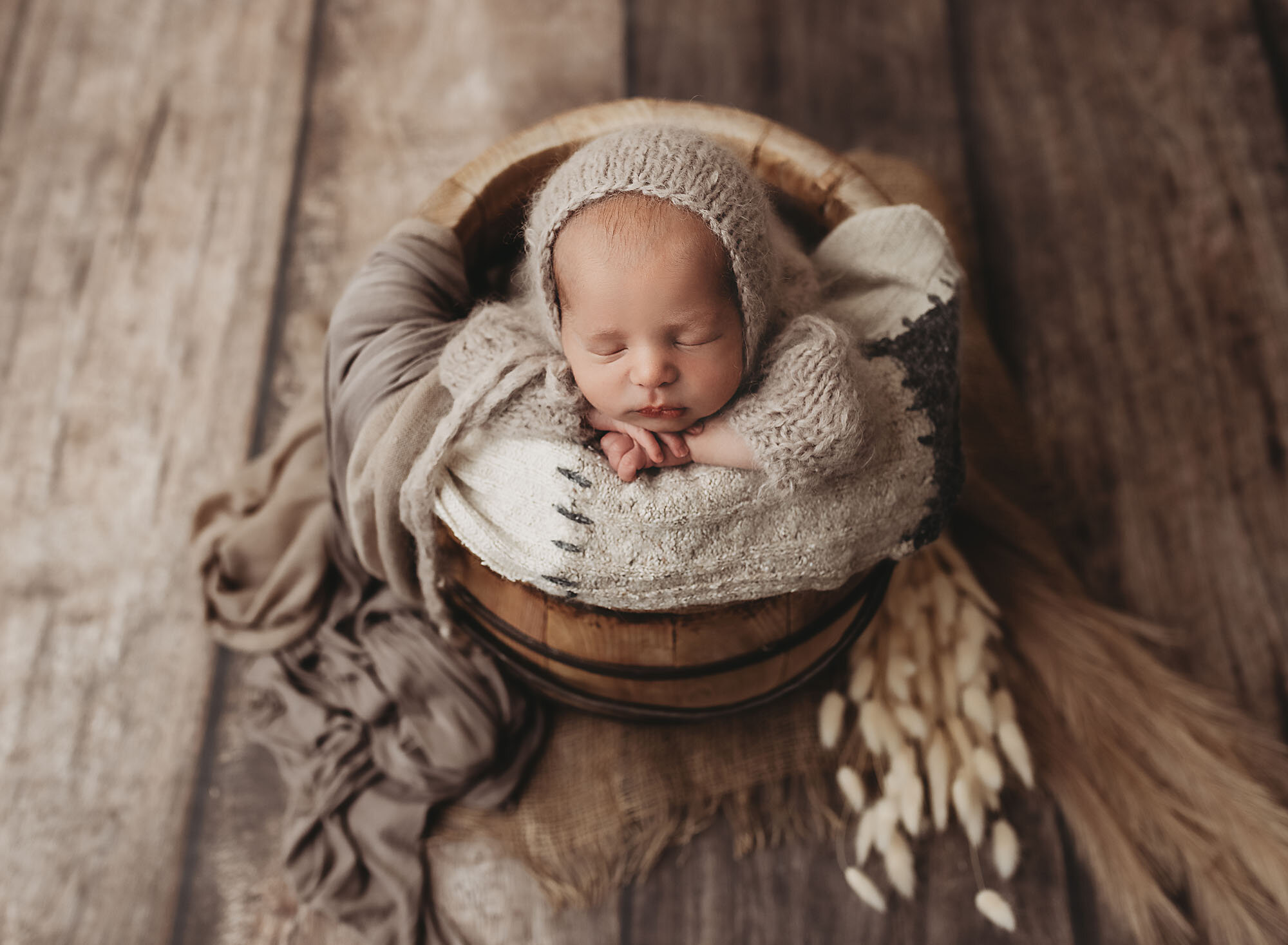 cute newborn baby in a bucket