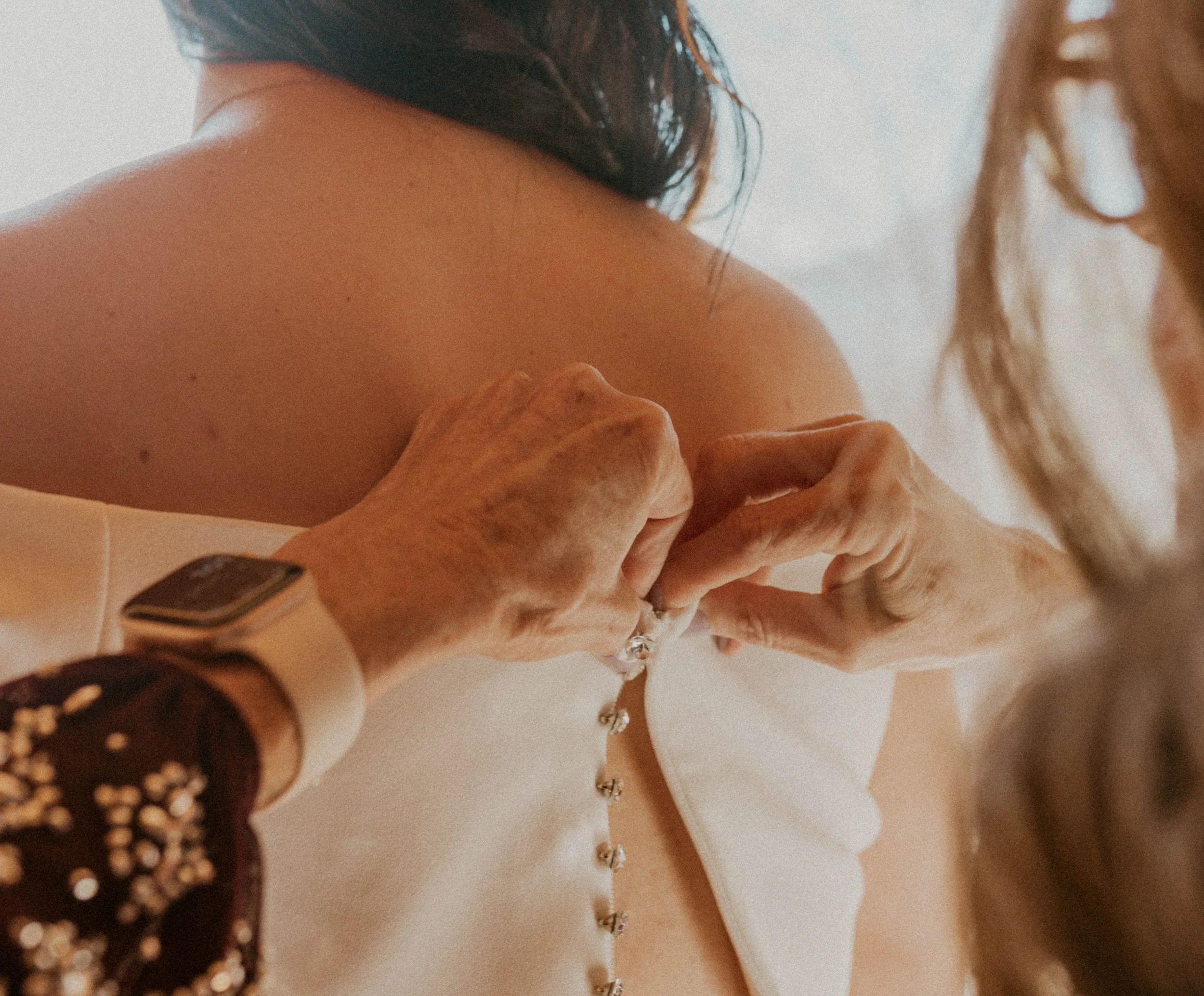 Bride putting on dress during relaxed Asheville elopement morning