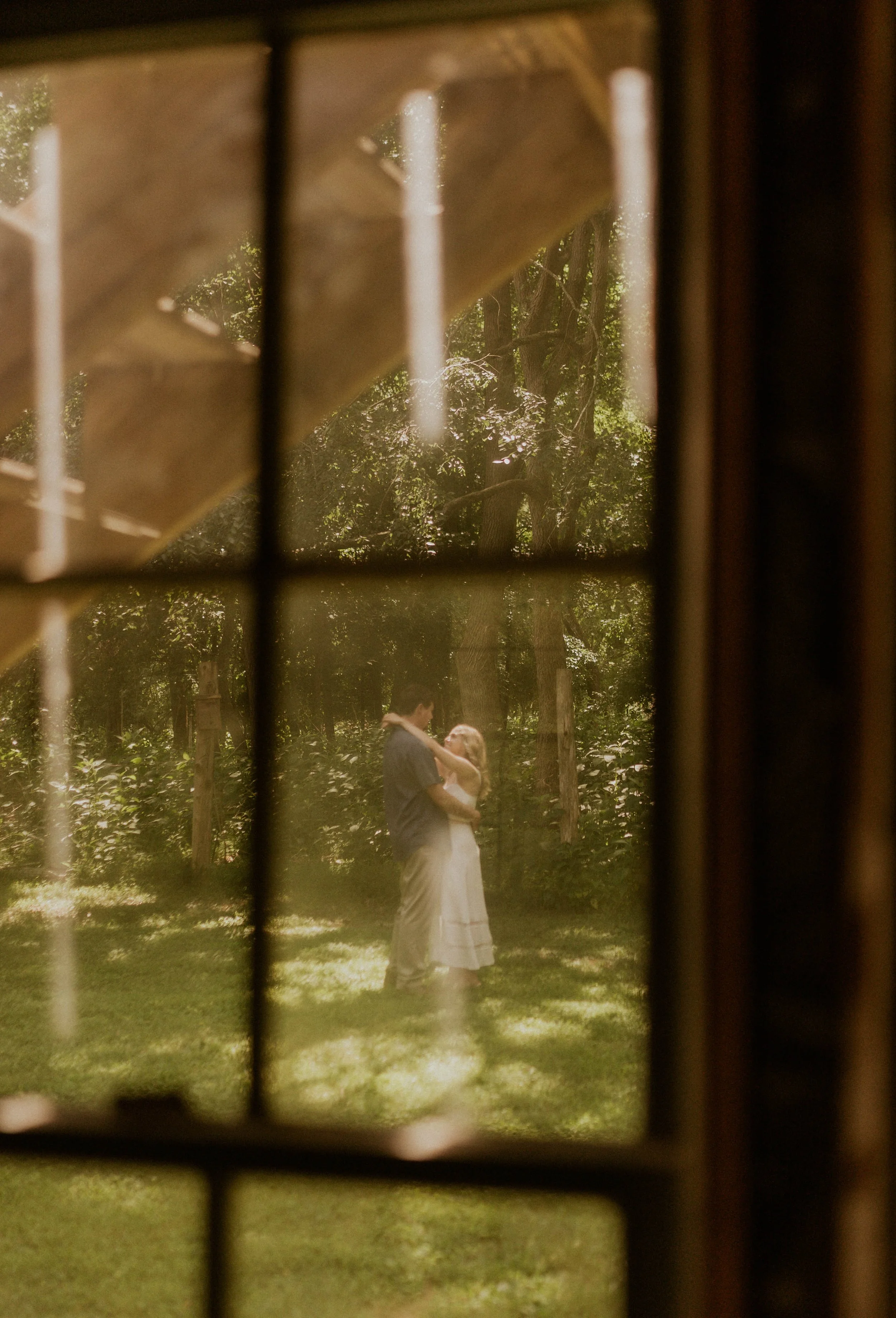 Couple wandering a family hobby farm before their elopement, picking berries and sharing quiet moments