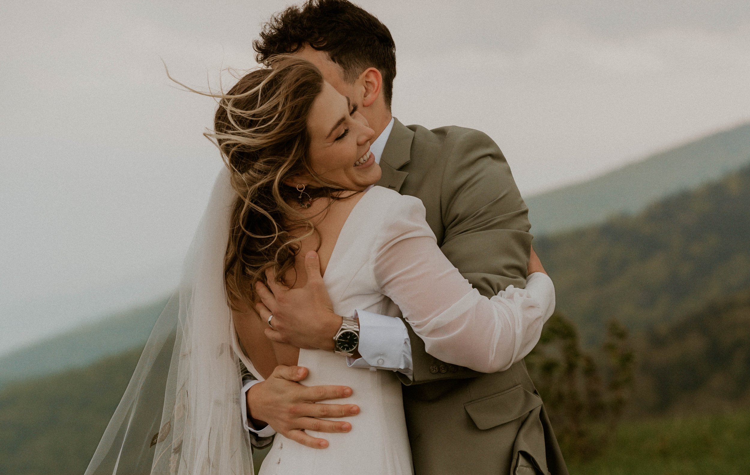 Couple embracing in the fog during intimate Roan Mountain elopement