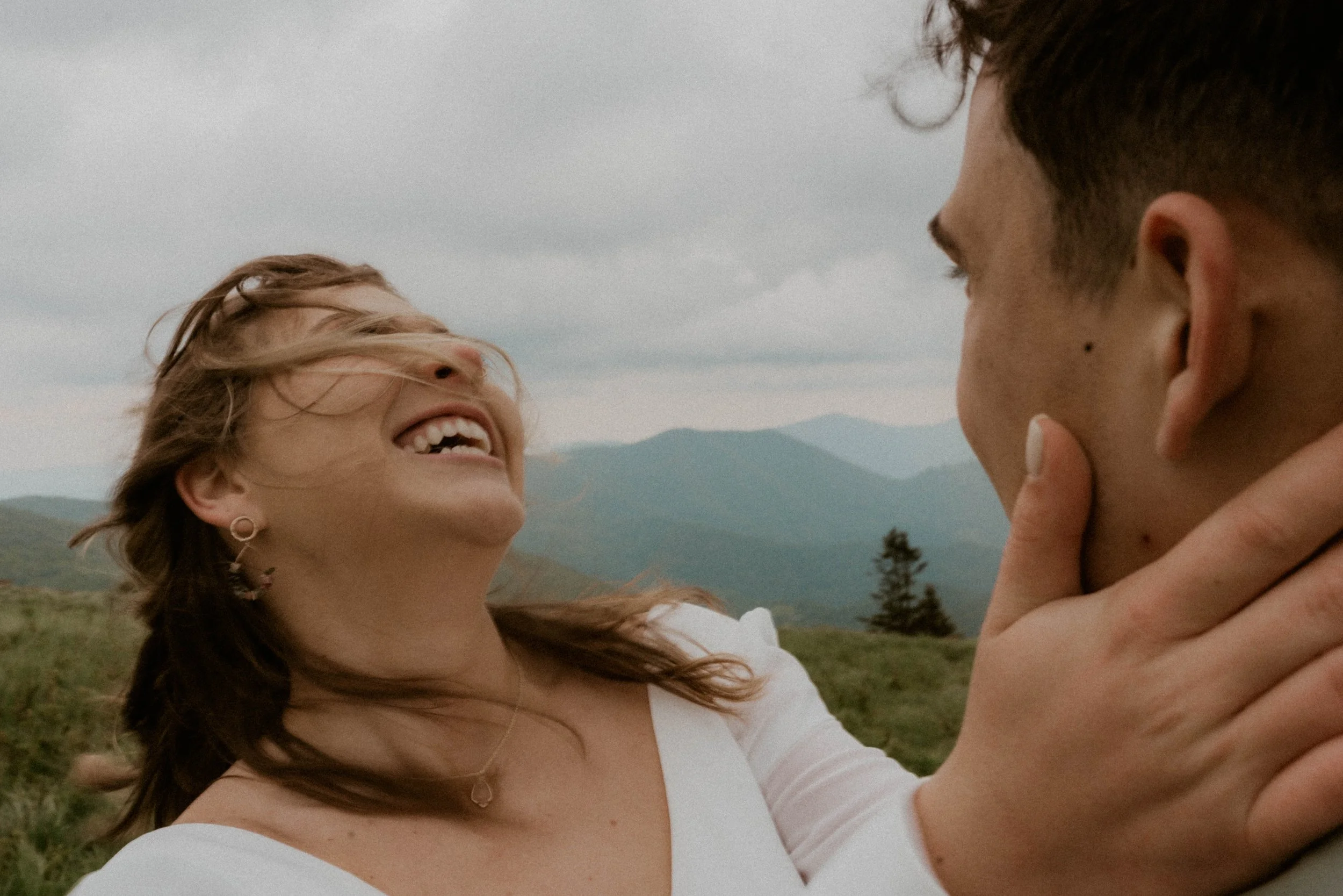 Bride wearing embroidered floral veil and hiking boots on Roan Mountain
