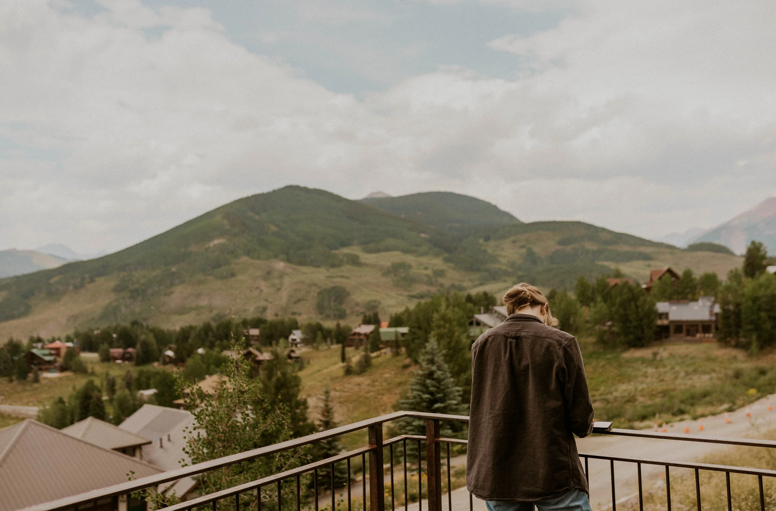 Bride writing wedding vows on the porch of a mountain Airbnb in Crested Butte, Colorado