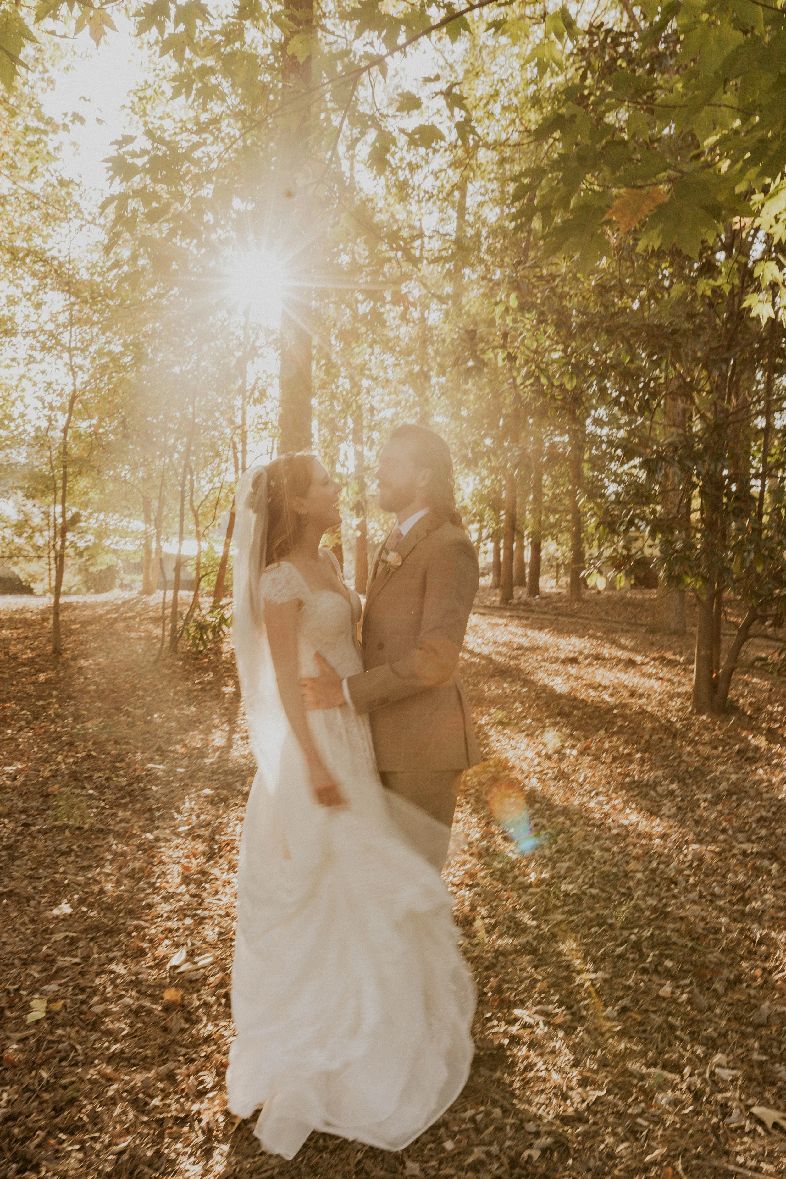 Newlyweds walking together through the gardens at Little Herb House