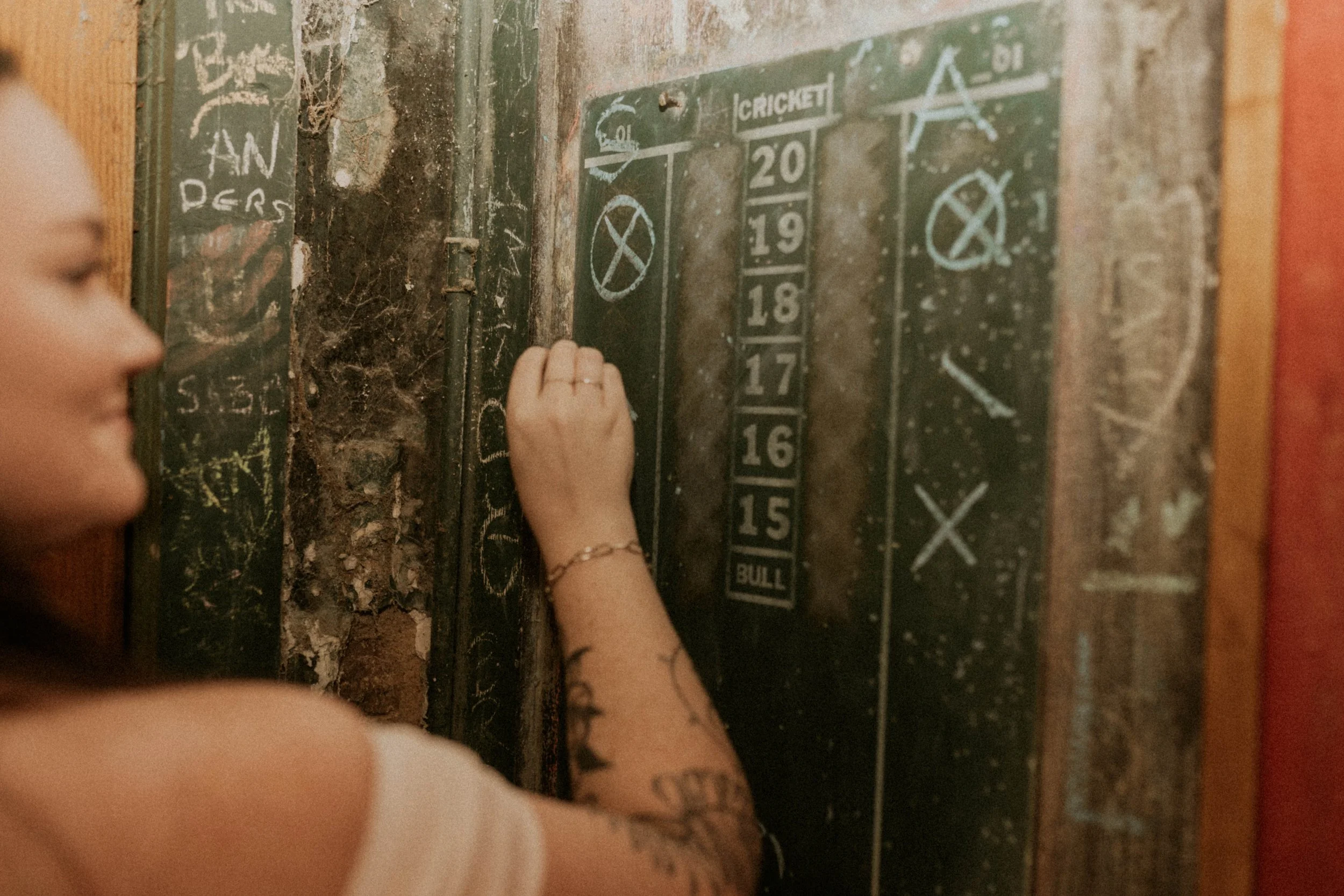 Engagement photos of couple playing darts during Durham date night session