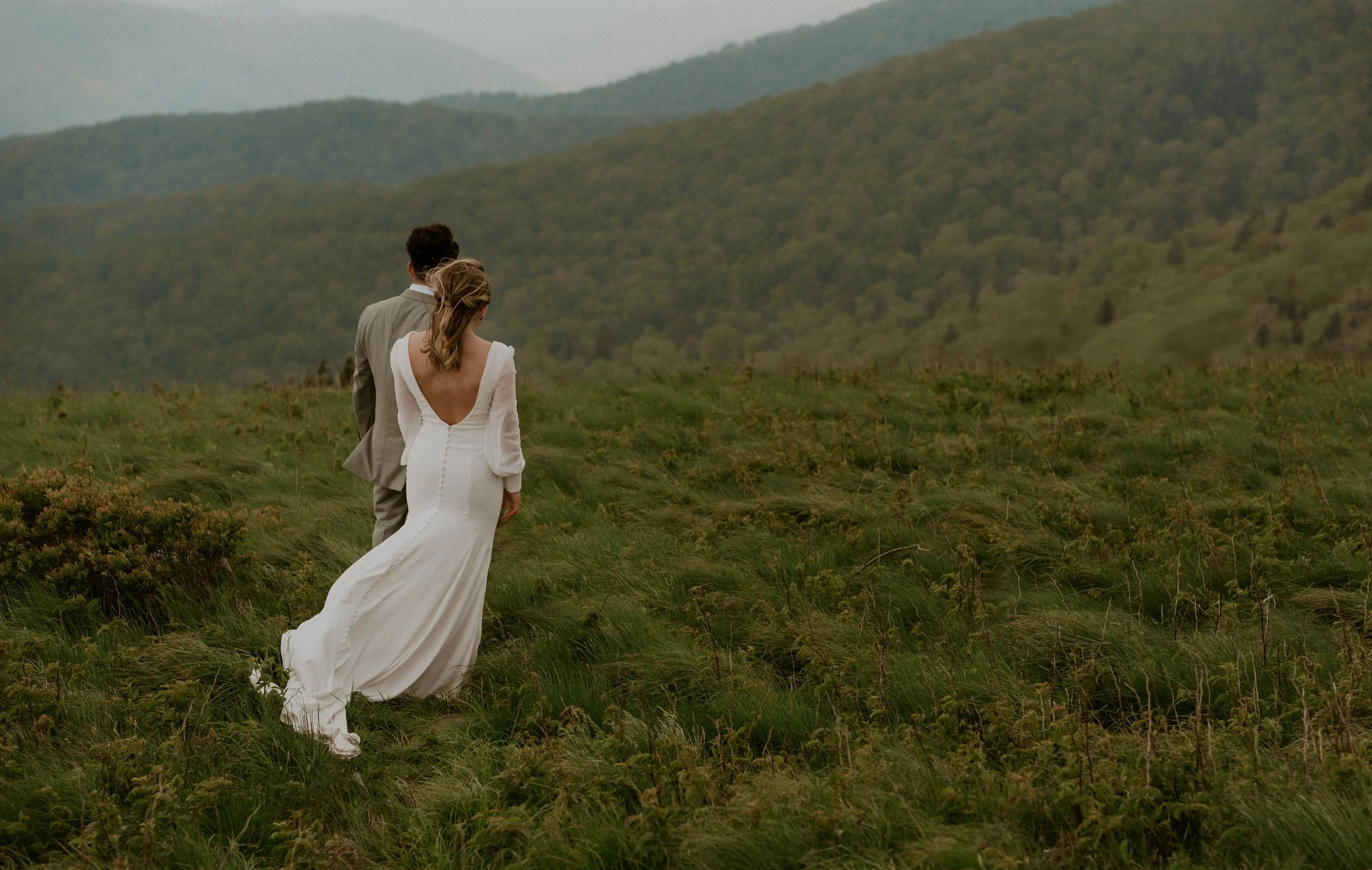 Bride wearing embroidered floral veil and hiking boots on Roan Mountain
