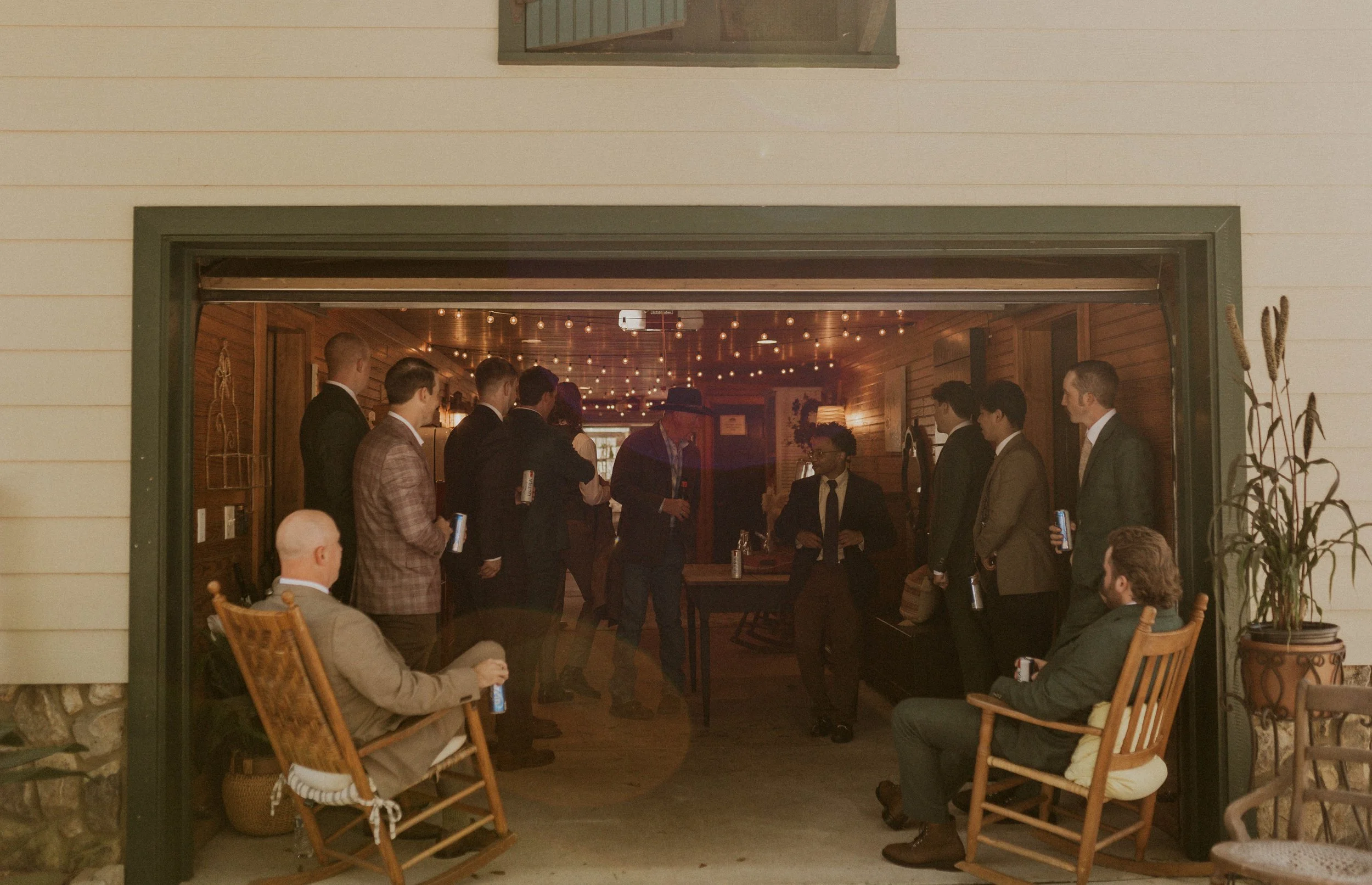Groom sharing beers and laughter with groomsmen before ceremony in Raleigh