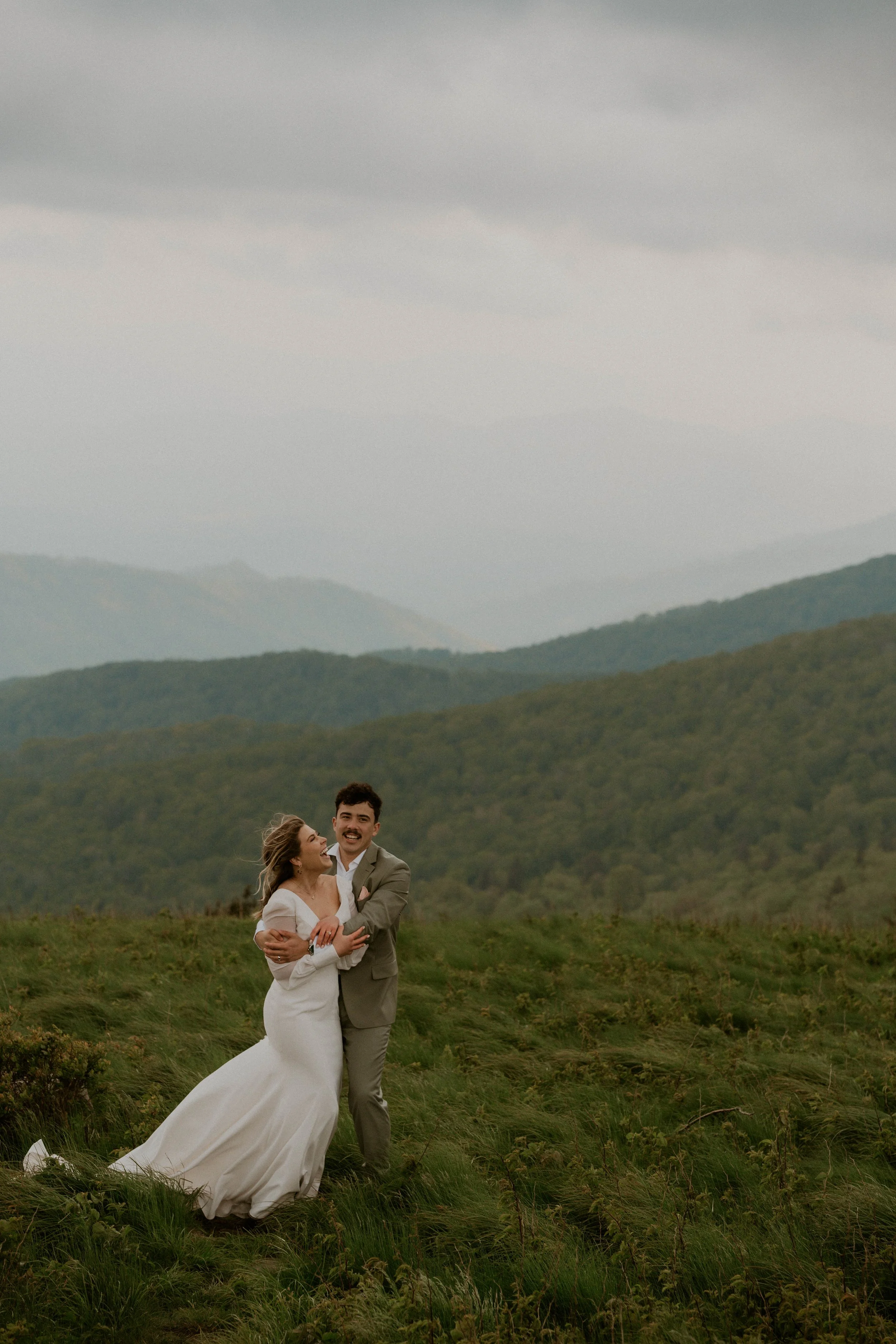 Bride wearing embroidered floral veil and hiking boots on Roan Mountain