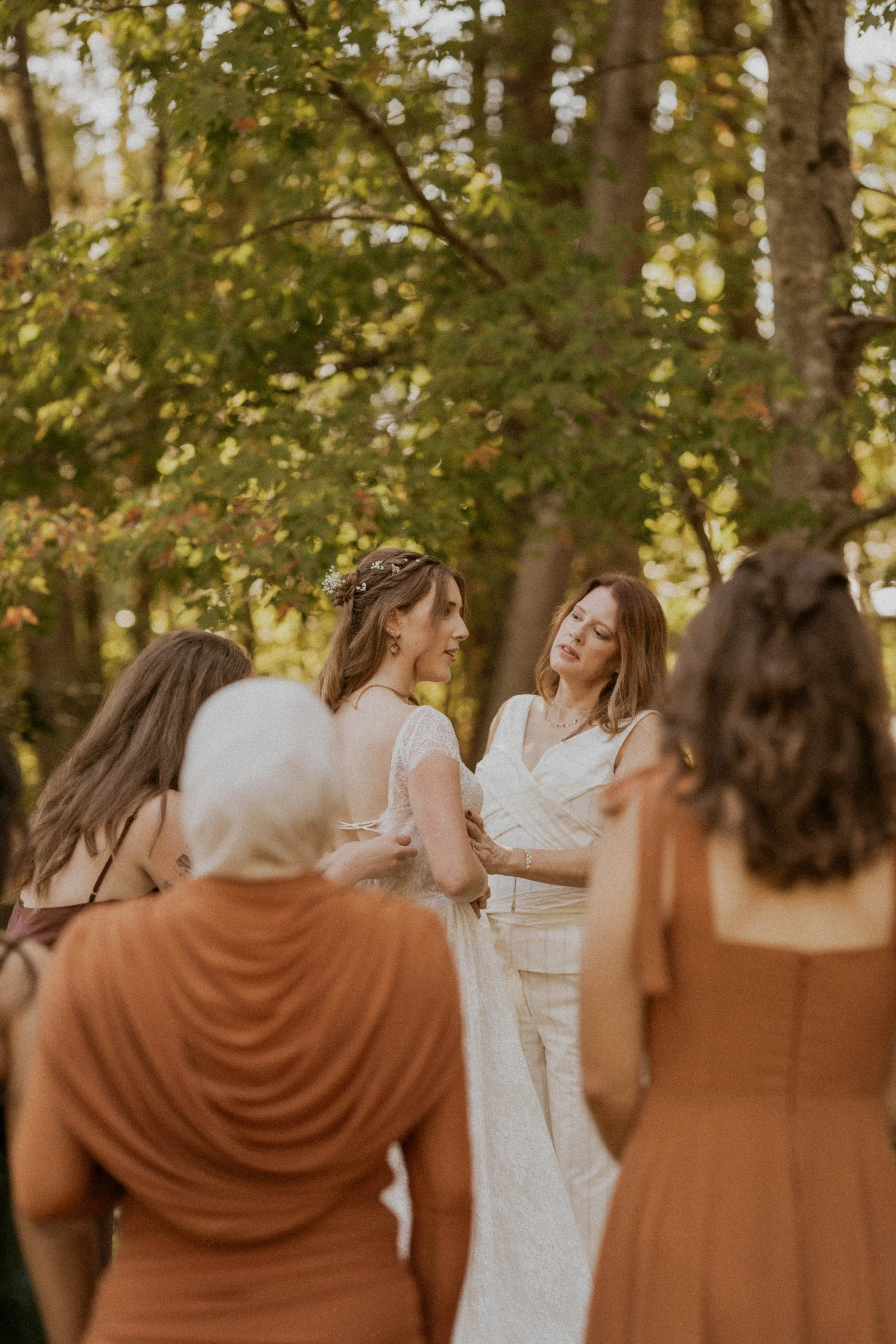 Bride getting ready with bridesmaids outdoors at The Little Herb House in Raleigh, NC