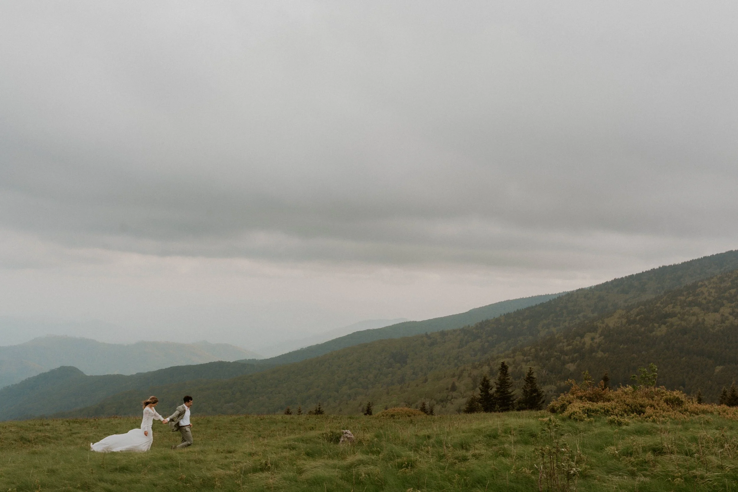 Bride wearing embroidered floral veil and hiking boots on Roan Mountain