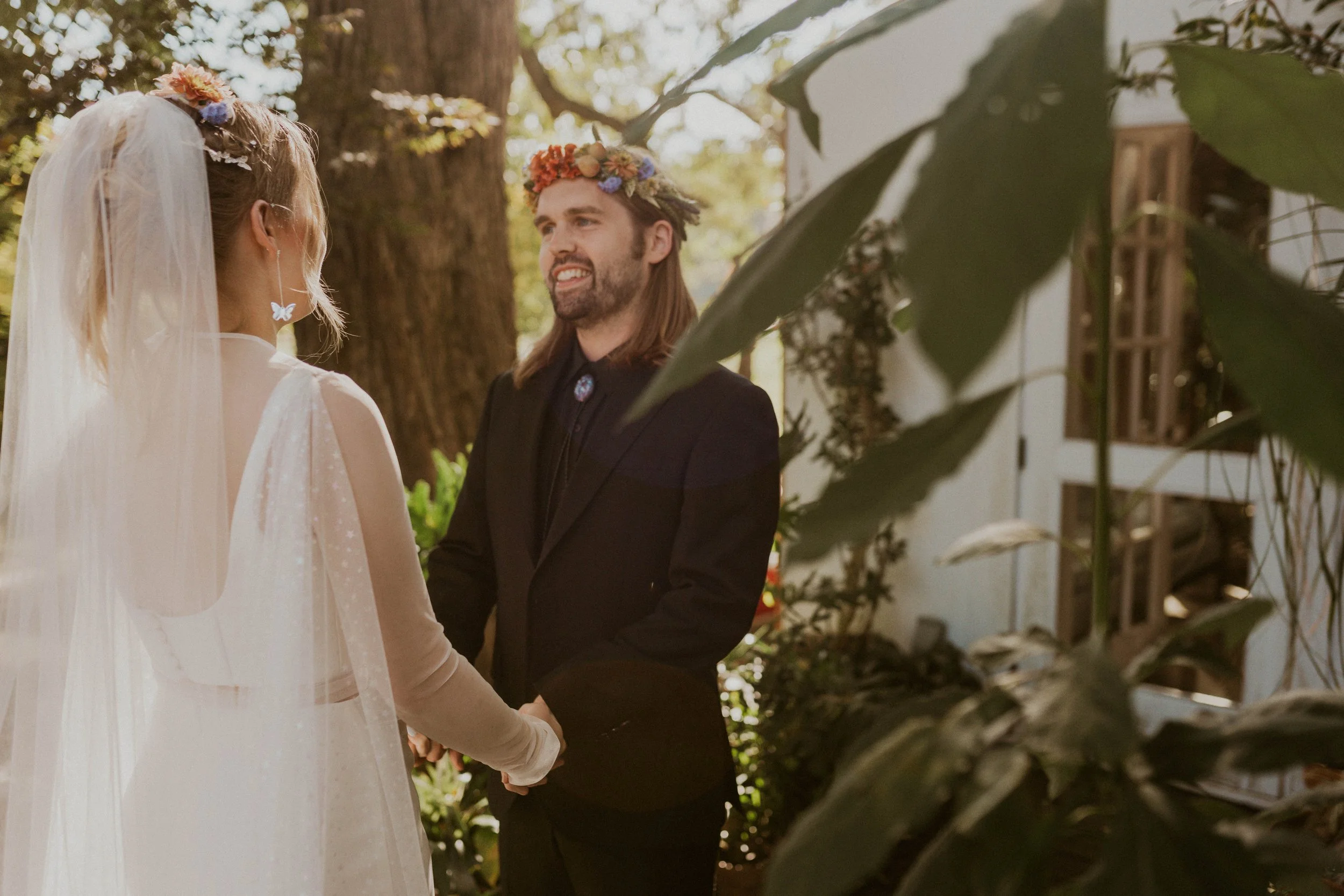 Sol and Ian laughing together during their first look on the farmhouse porch