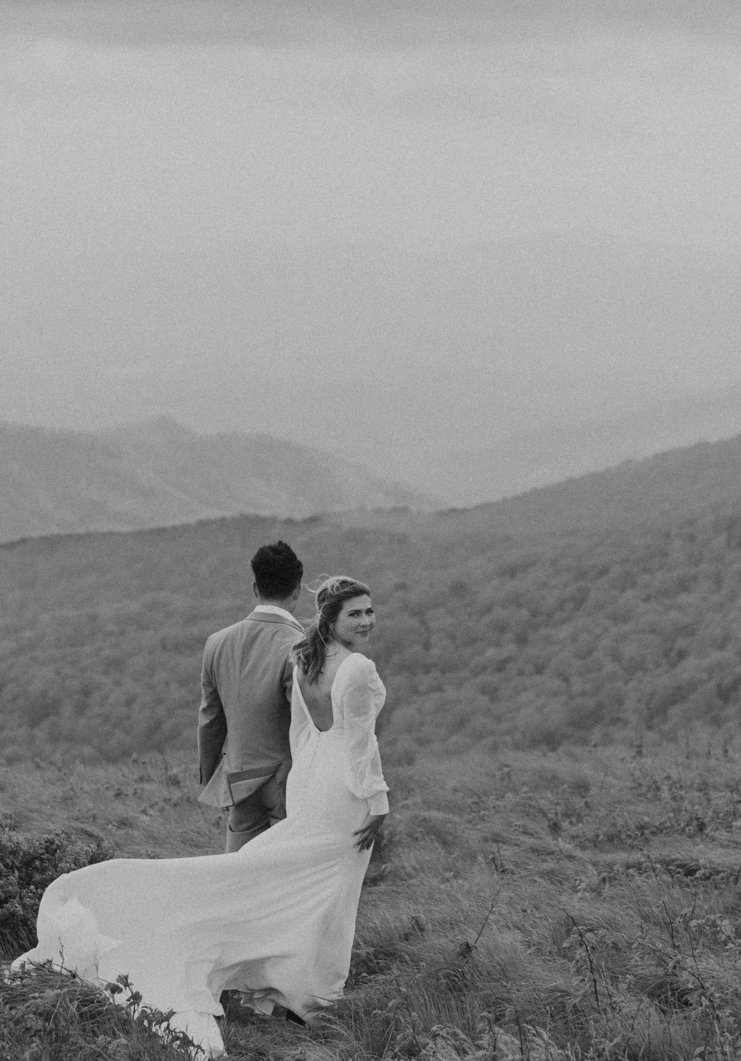 Bride wearing embroidered floral veil and hiking boots on Roan Mountain