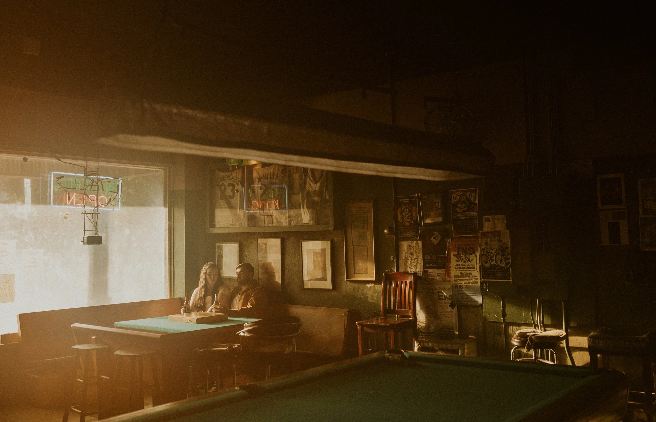 Candid engagement photography inside Durham pool hall date night