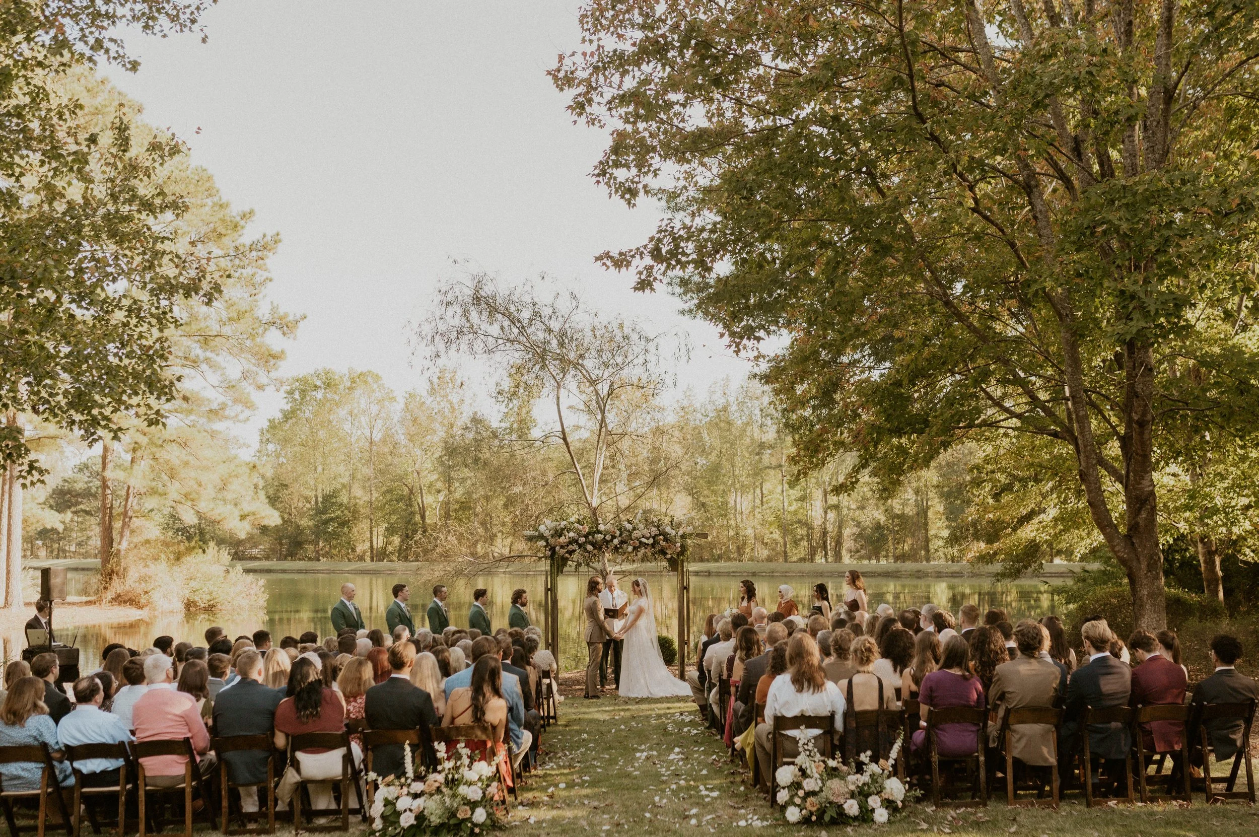 Couple exchanging vows in a durham lakeside wedding