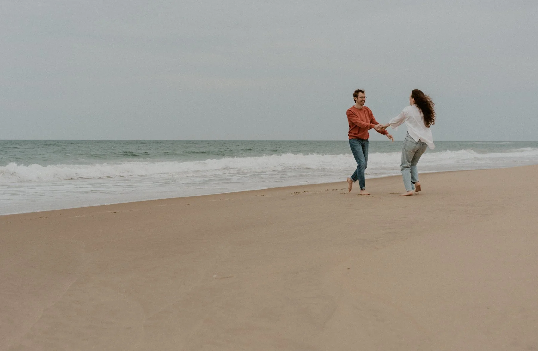 couple standing in misty dunes Outer Banks NC
