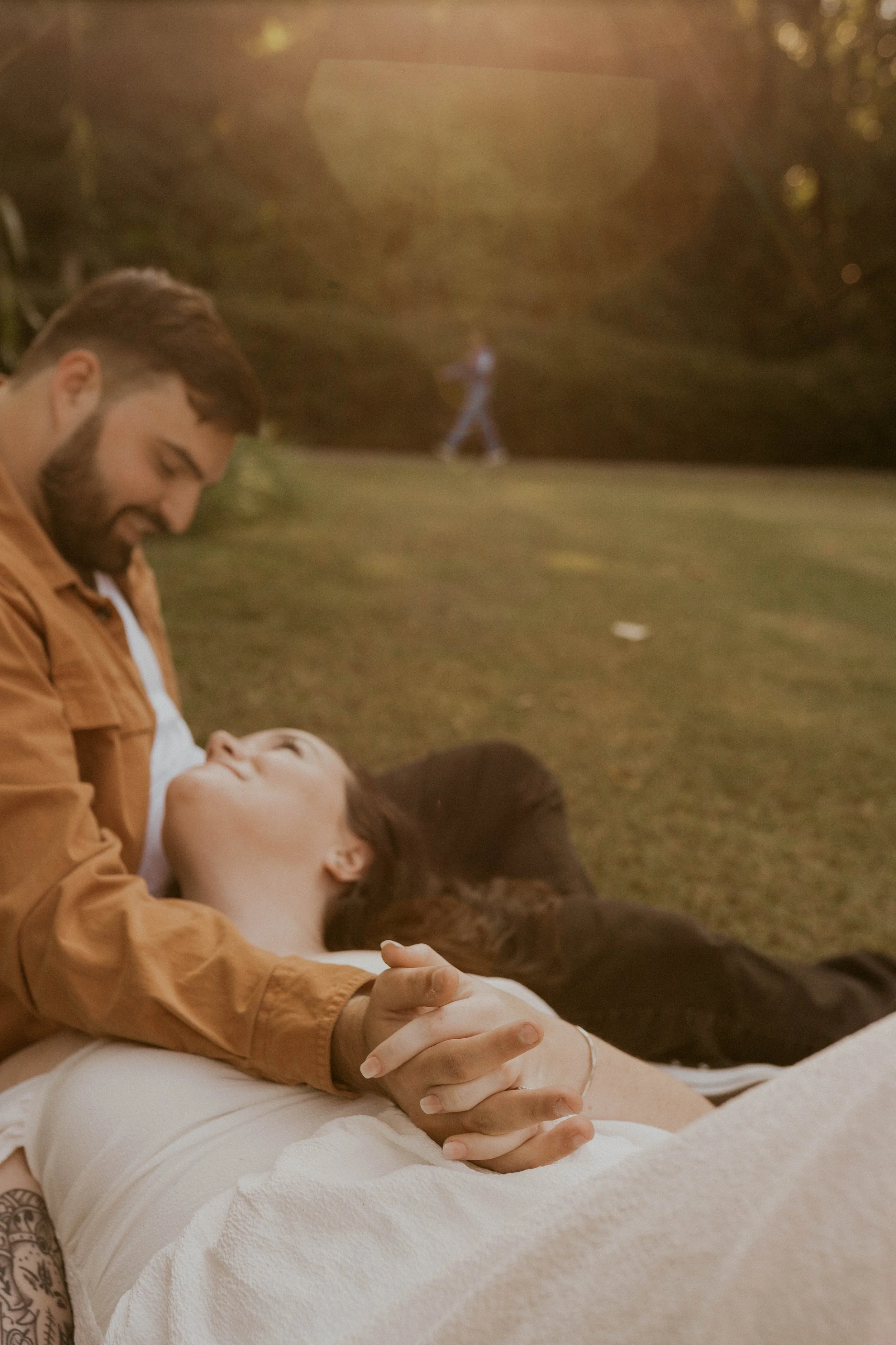 Couple laughing together during golden hour engagement photos in Durham NC