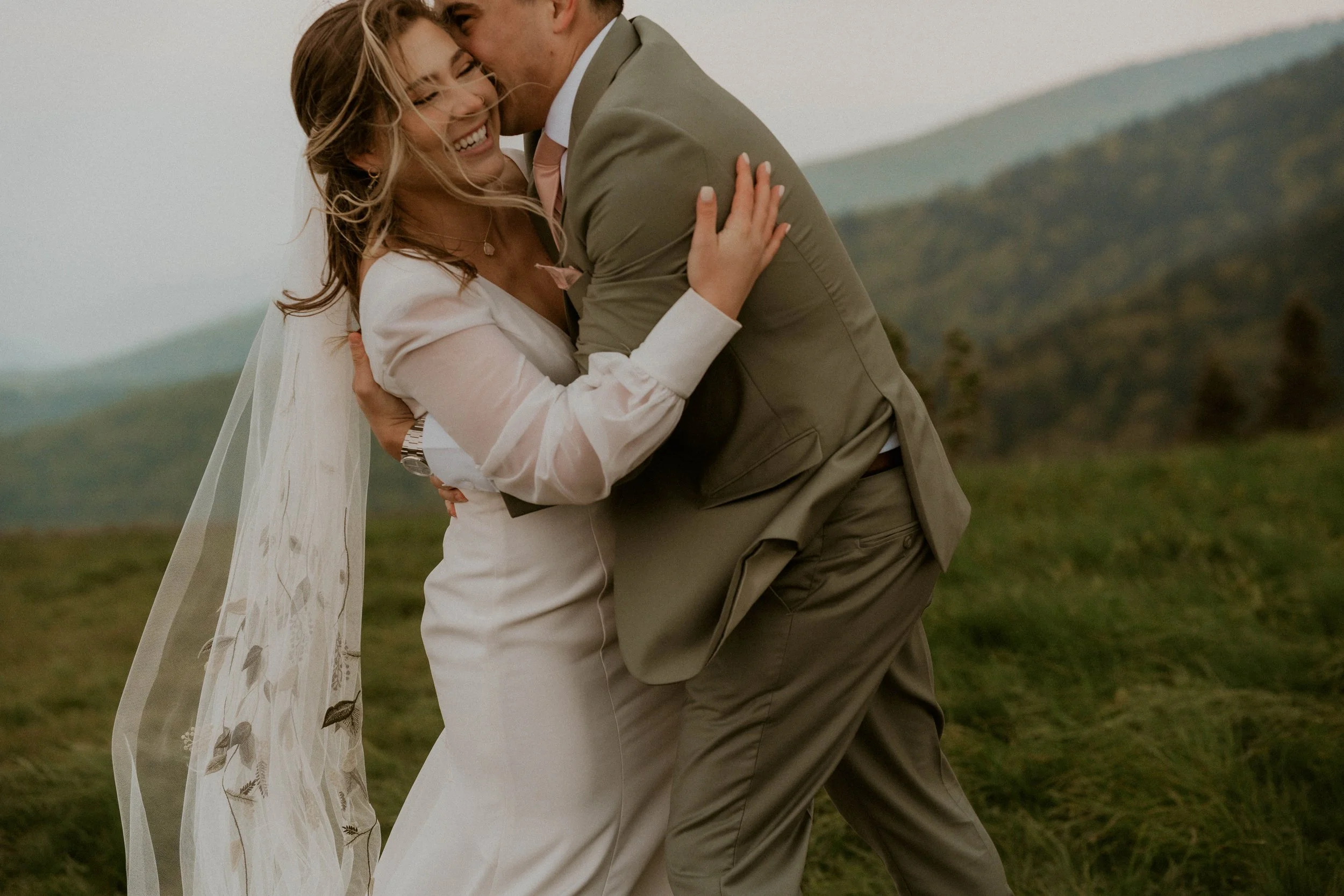 Couple embracing in the fog during intimate Roan Mountain elopement