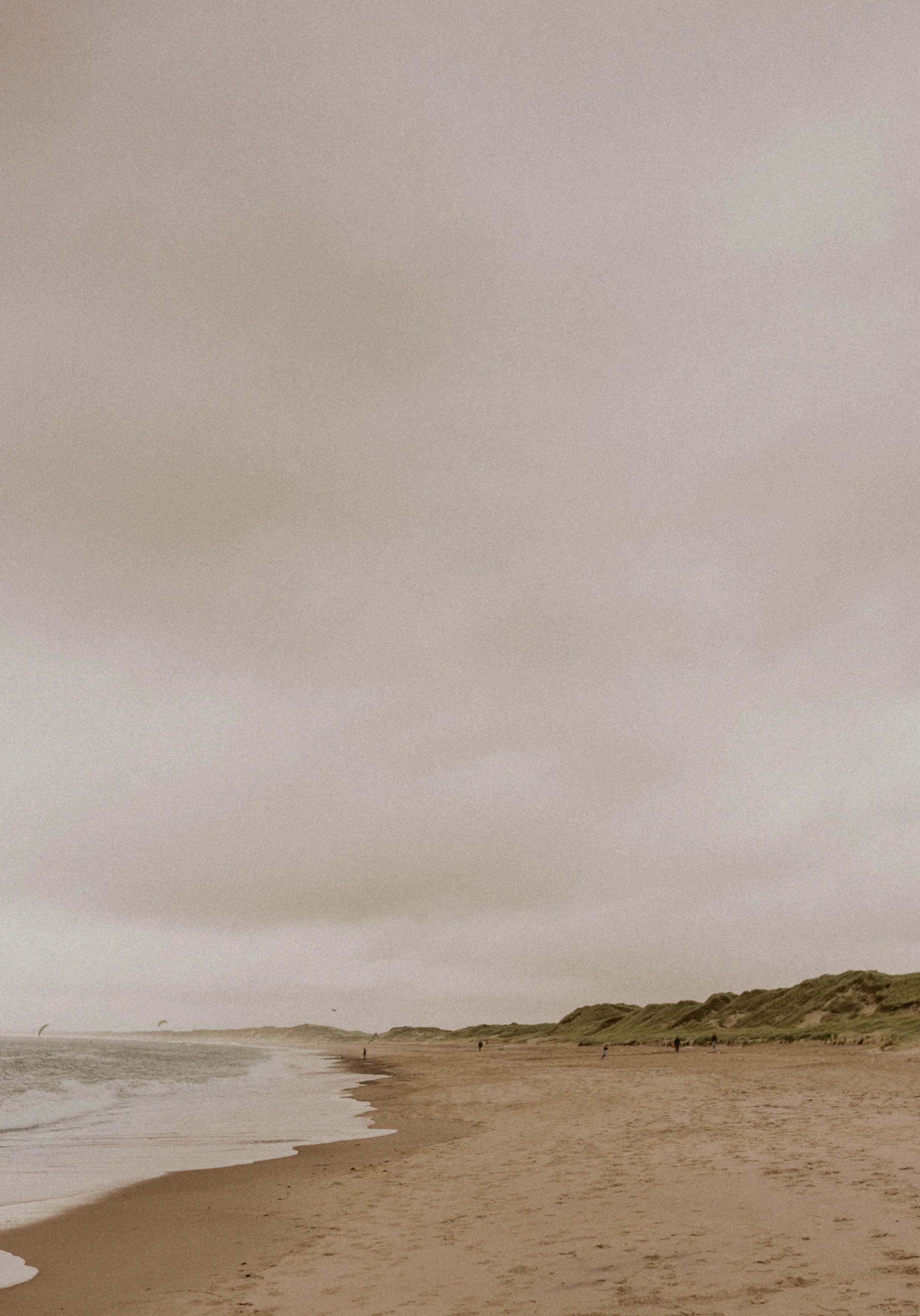 Moody Denmark elopement on the Danish West Coast with rolling dunes and dramatic sky