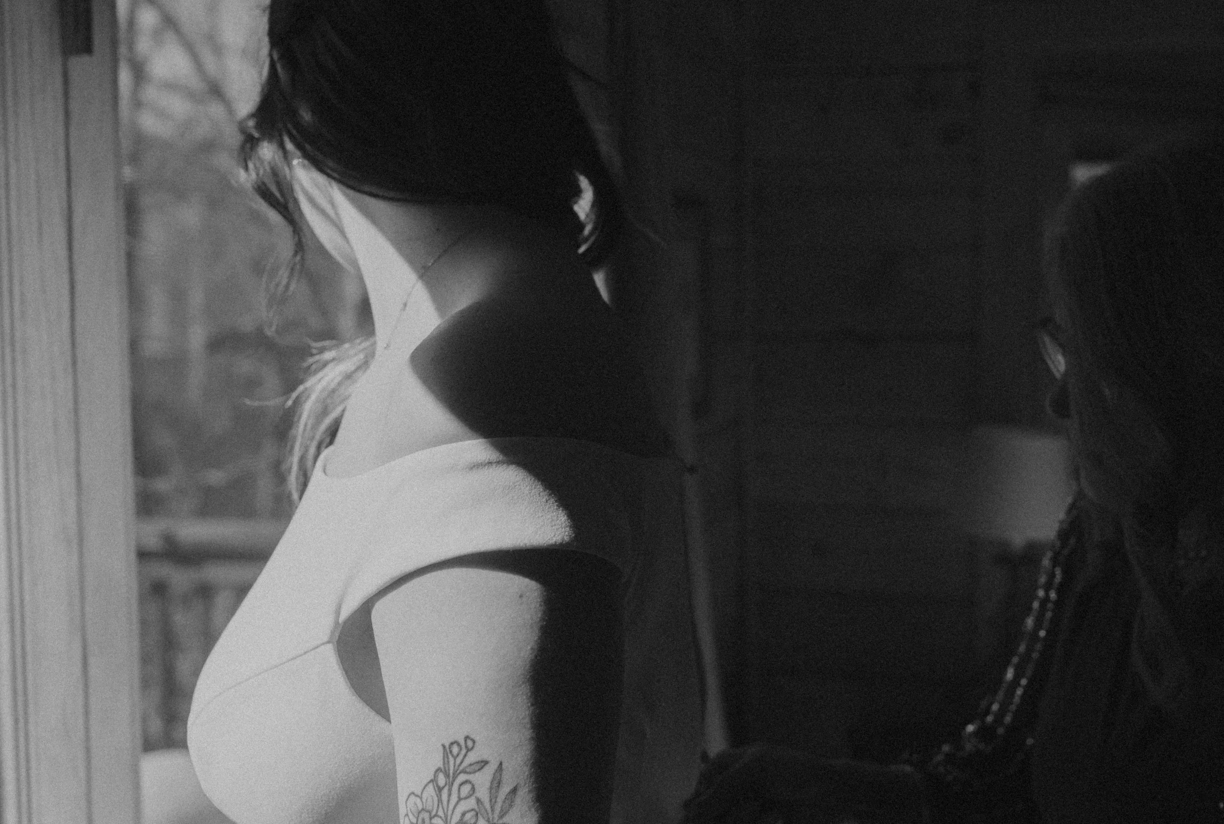 Bride putting on dress during relaxed Asheville elopement morning