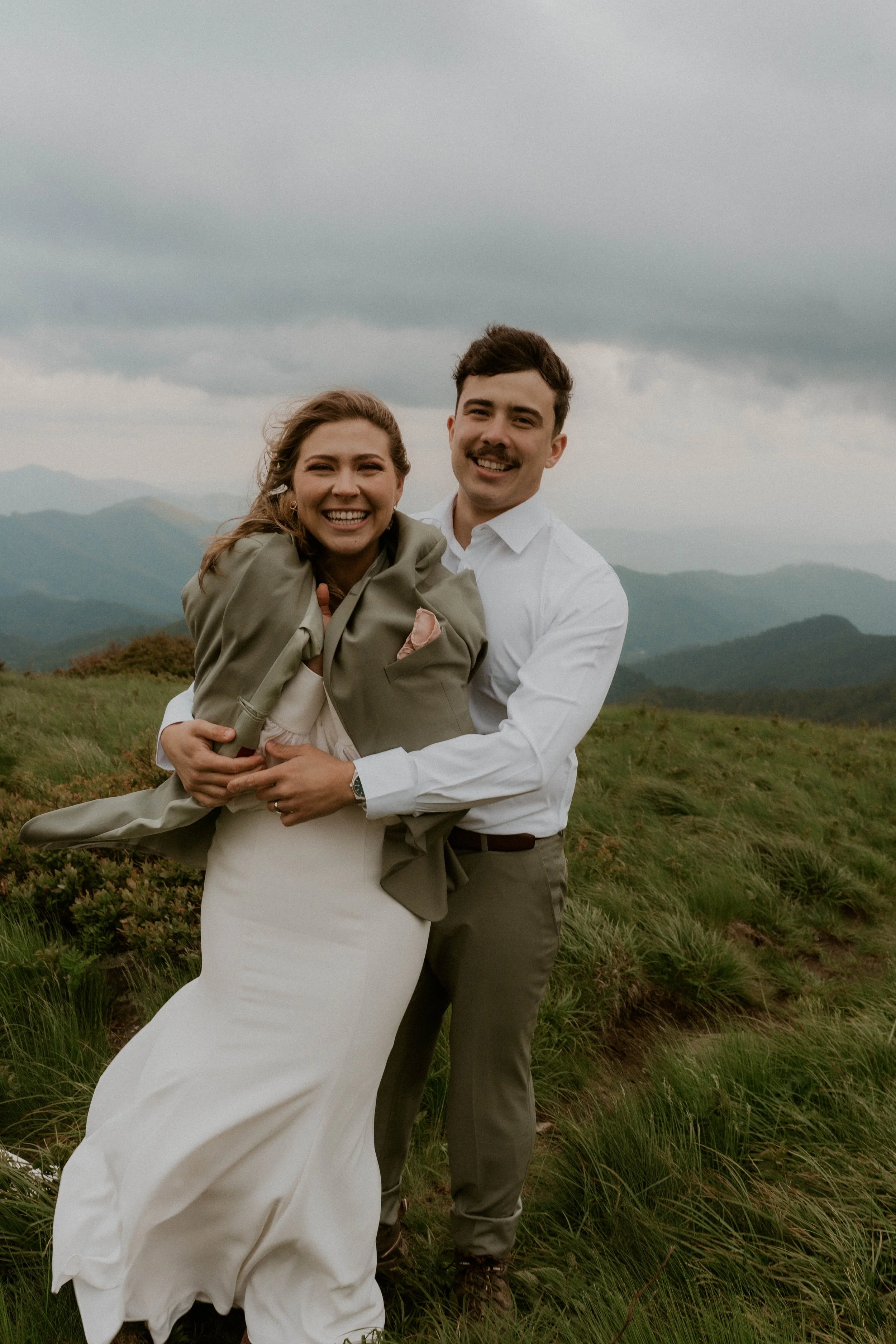 Bride wearing embroidered floral veil and hiking boots on Roan Mountain