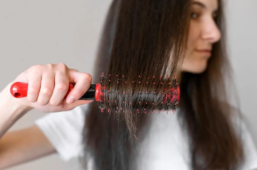 Hair collected in a brush due to hair thinning.webp