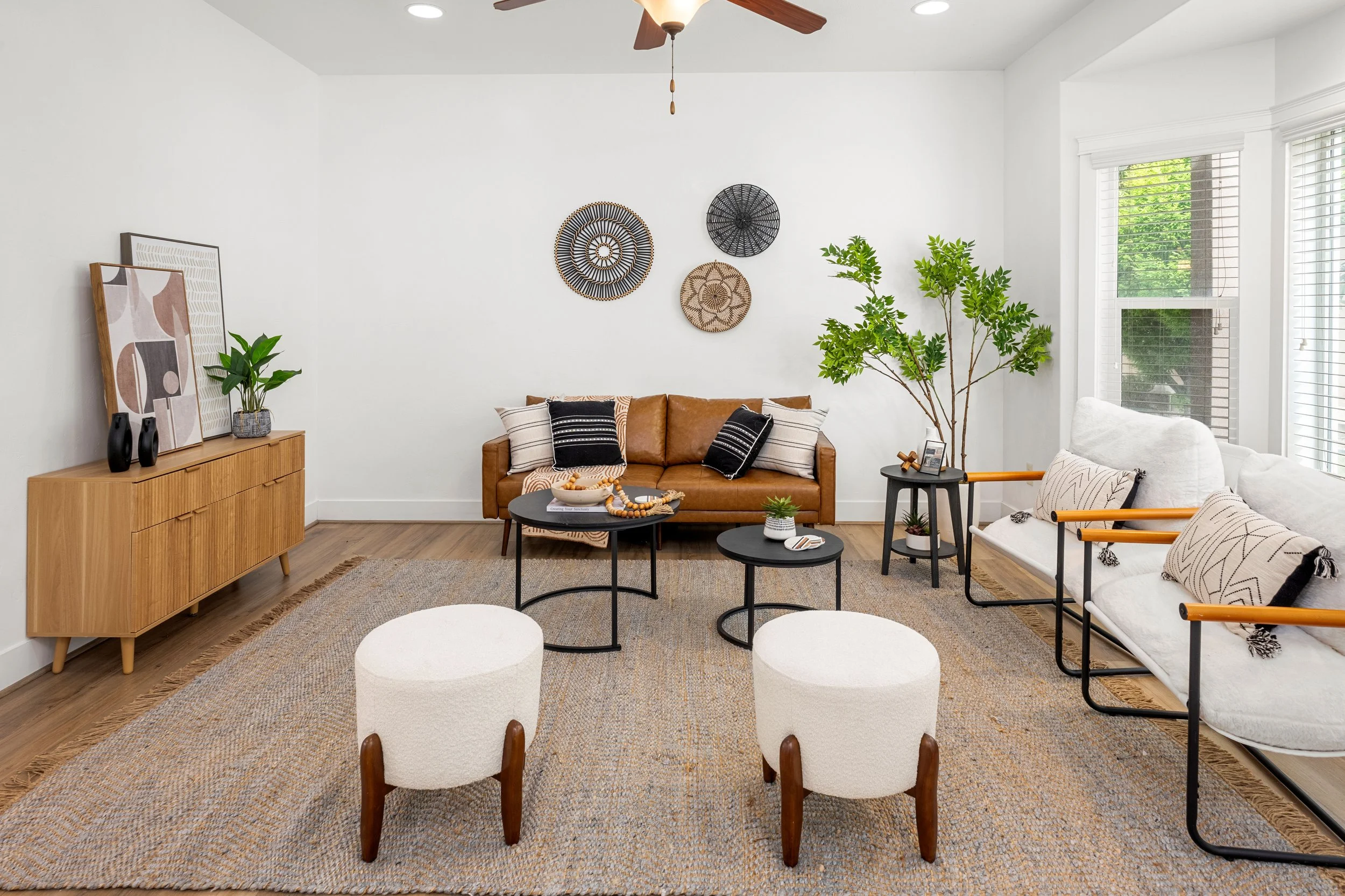 beautifully staged modern furniture in living room with bay window