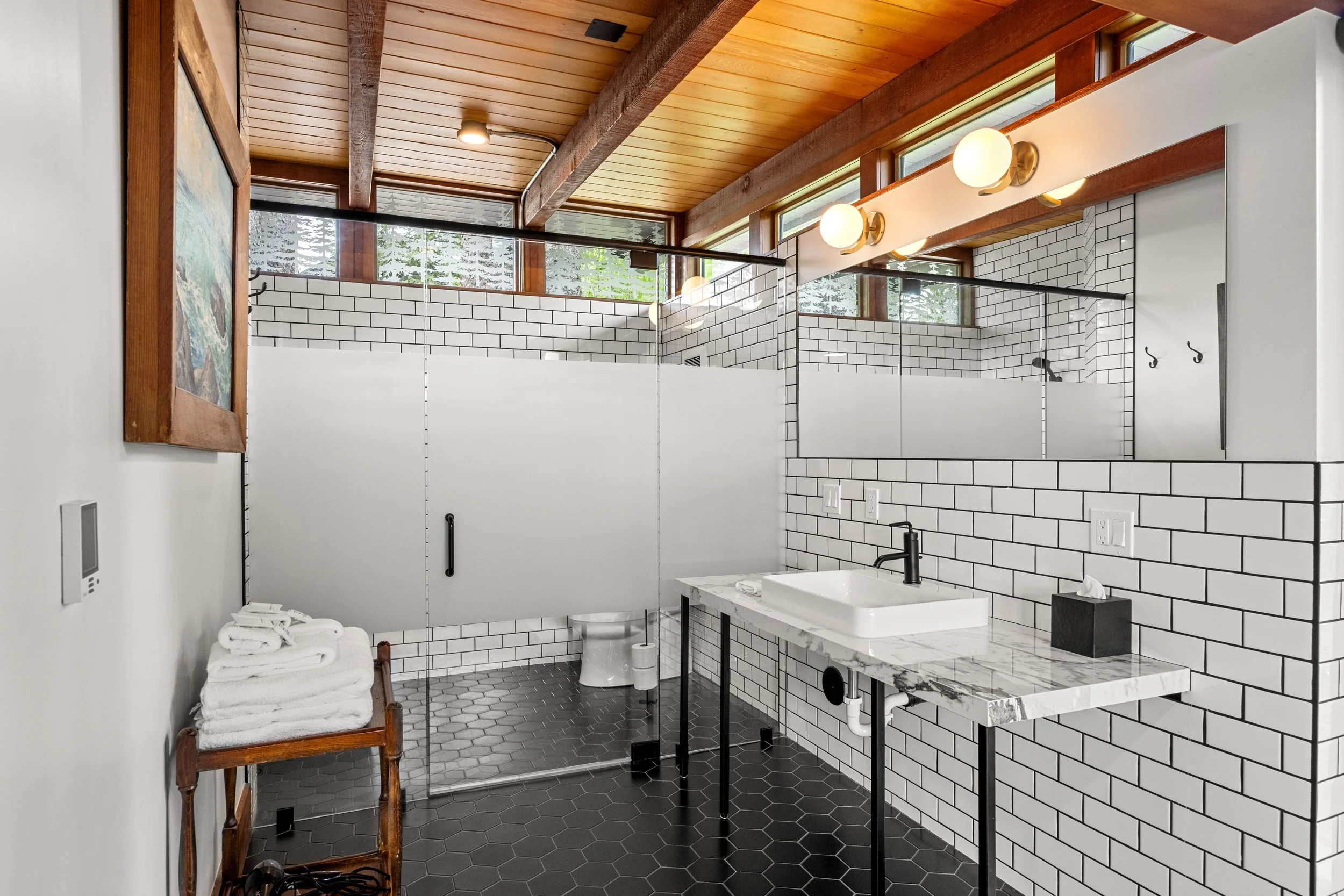 A modern industrial bathroom design in the Glass House, McCall Idaho