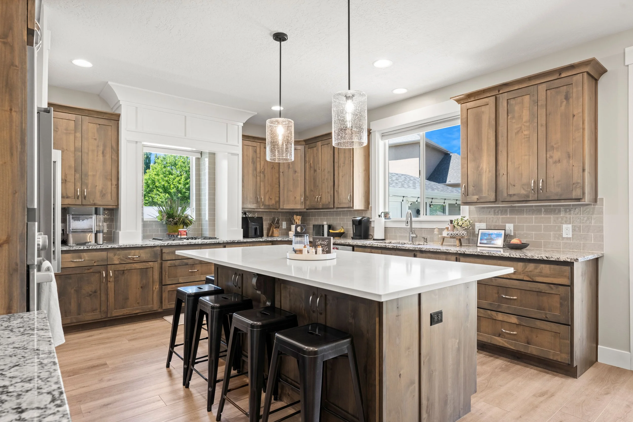 large kitchen island surrounded by warm wood counters and storage on 3 sides