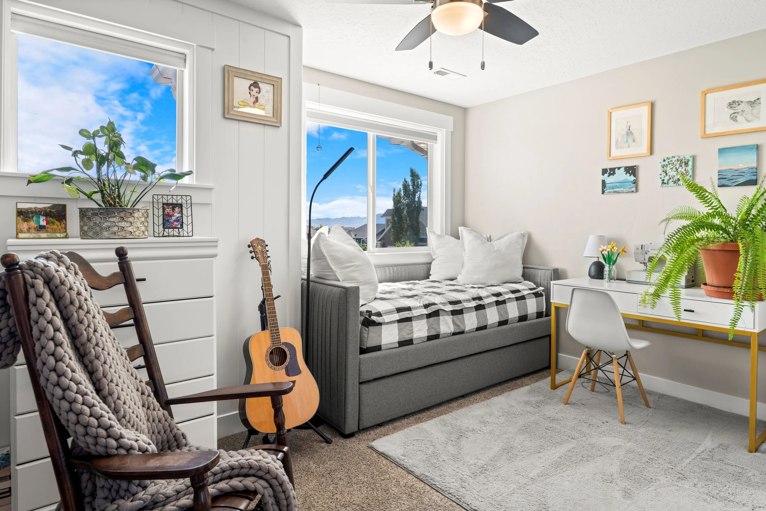 cozy reading room with day bed, natural light, plants and desk